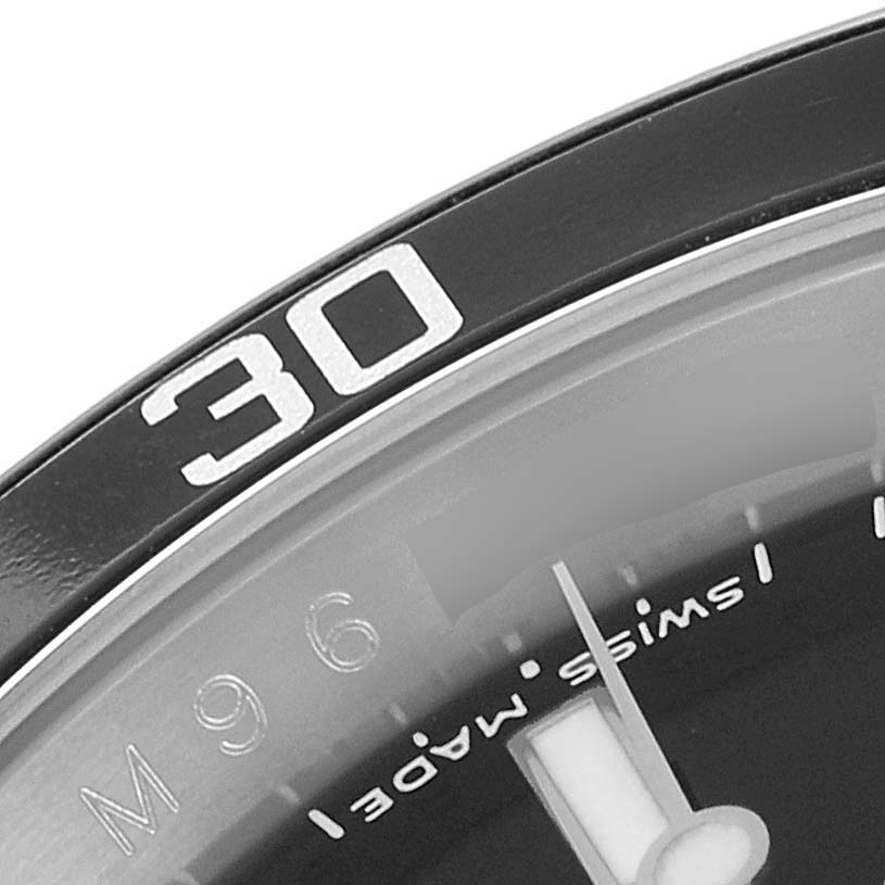This close-up angle of the Rolex Submariner 16610 Men
s Stainless Steel Black Dial 16610 Men
s Stainless Steel Black Dial watch shows the bezel
s "30" marker and part of the dial indicating "Swiss Made."