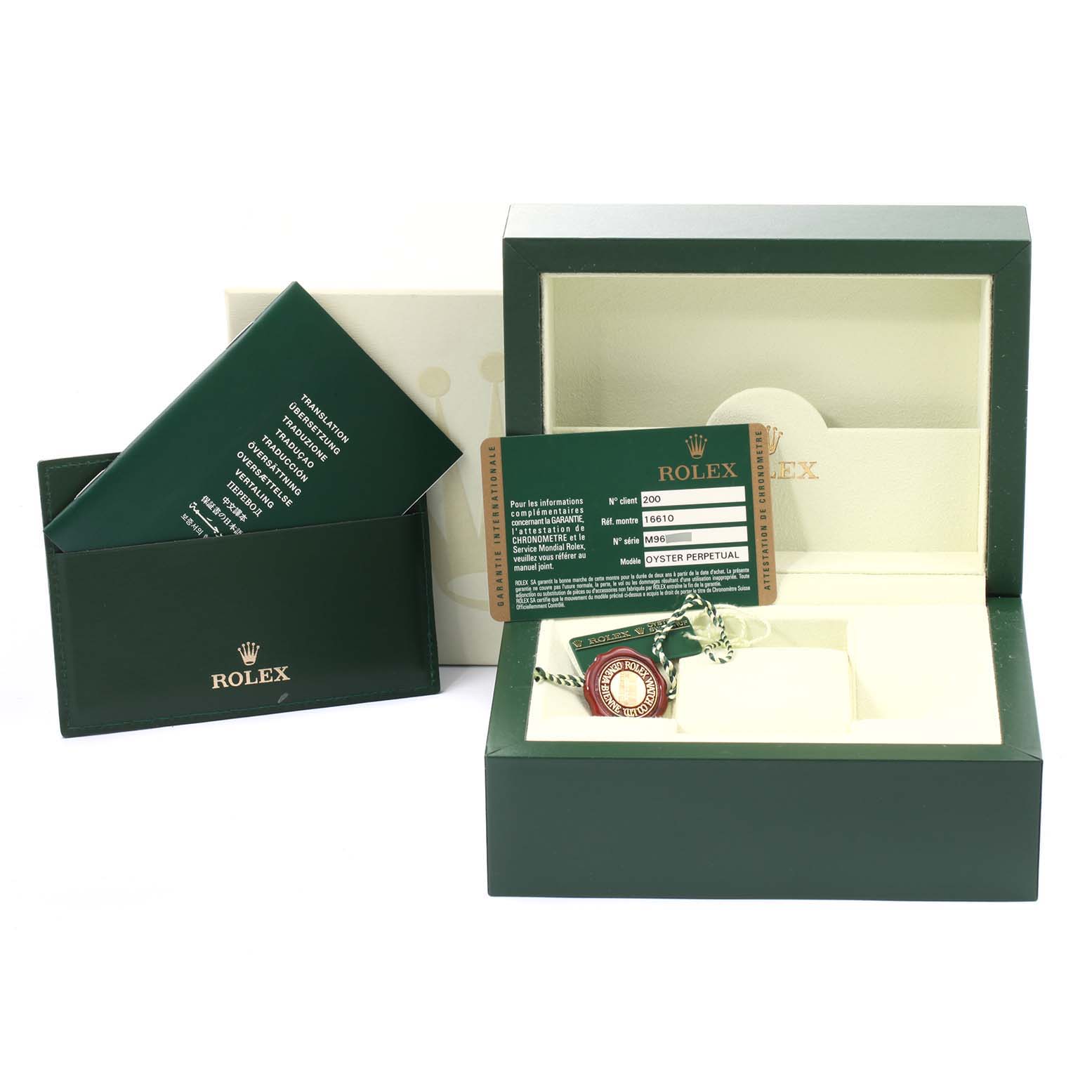 The image shows the accessories for a Rolex Submariner 16610 Men
s Stainless Steel Black Dial 16610 Men
s Stainless Steel Black Dial, including its box, warranty card, and tags.
