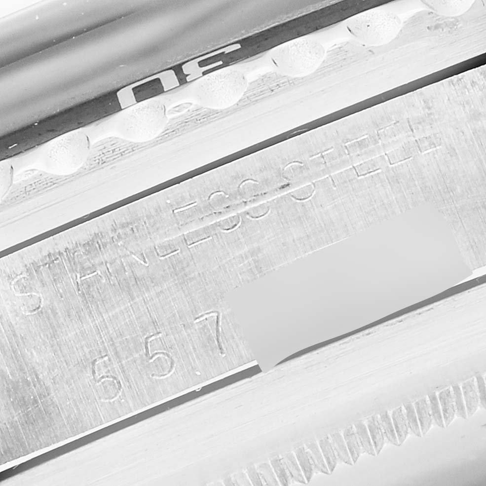 Close-up of the side of a Rolex Vintage Collection 1680 Men's Stainless Steel Black Dial 1680 Men's Stainless Steel Black Dial watch showing the serial number and "STAINLESS STEEL" engraving.