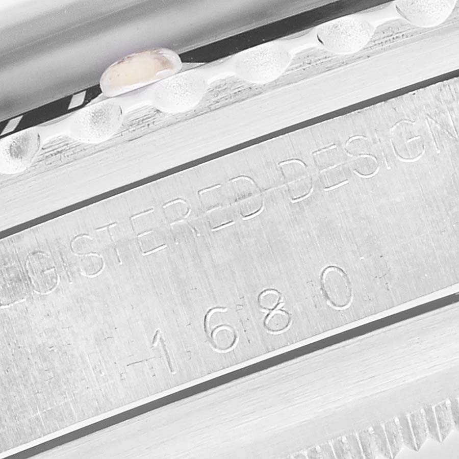 This close-up angle shows the engraved side and bezel edge of a Vintage Collection Rolex watch, model 1680.