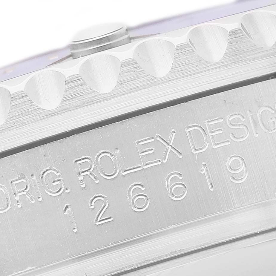 The image shows a close-up of the side of the Rolex Submariner 126619 Men's White Gold Black Dial, featuring the engraved model number and notched bezel edge.