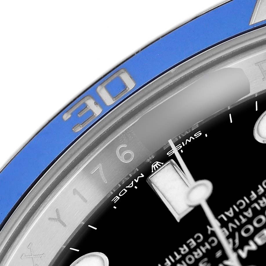 The image shows a close-up of the bezel, dial, and markers of a Rolex Submariner 126619 Men's White Gold Black Dial watch at an angle.