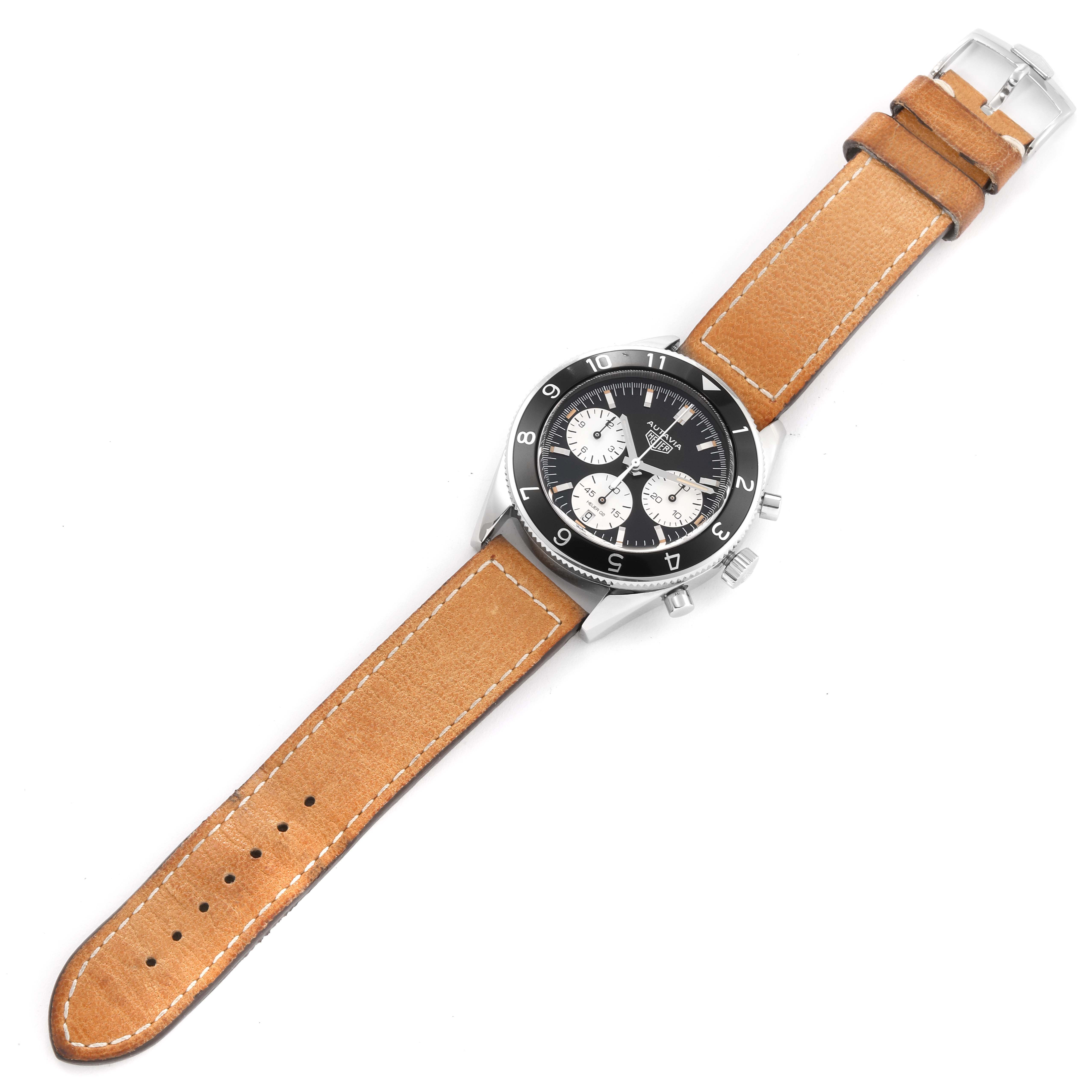 The Tag Heuer Autavia CBE2110 Men's Stainless Steel Black Dial CBE2110 Men's Stainless Steel Black Dial watch is shown in a top-down angle, displaying its dial, bezel, case, and leather strap.