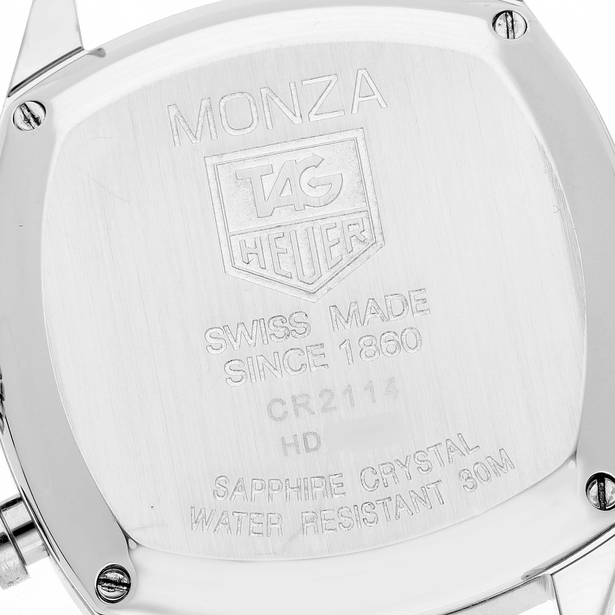 The image shows the back case of a Tag Heuer Monza CR2114 Men's Stainless Steel Silver Dial CR2114 Men's Stainless Steel Silver Dial watch, highlighting its engravings and screws.