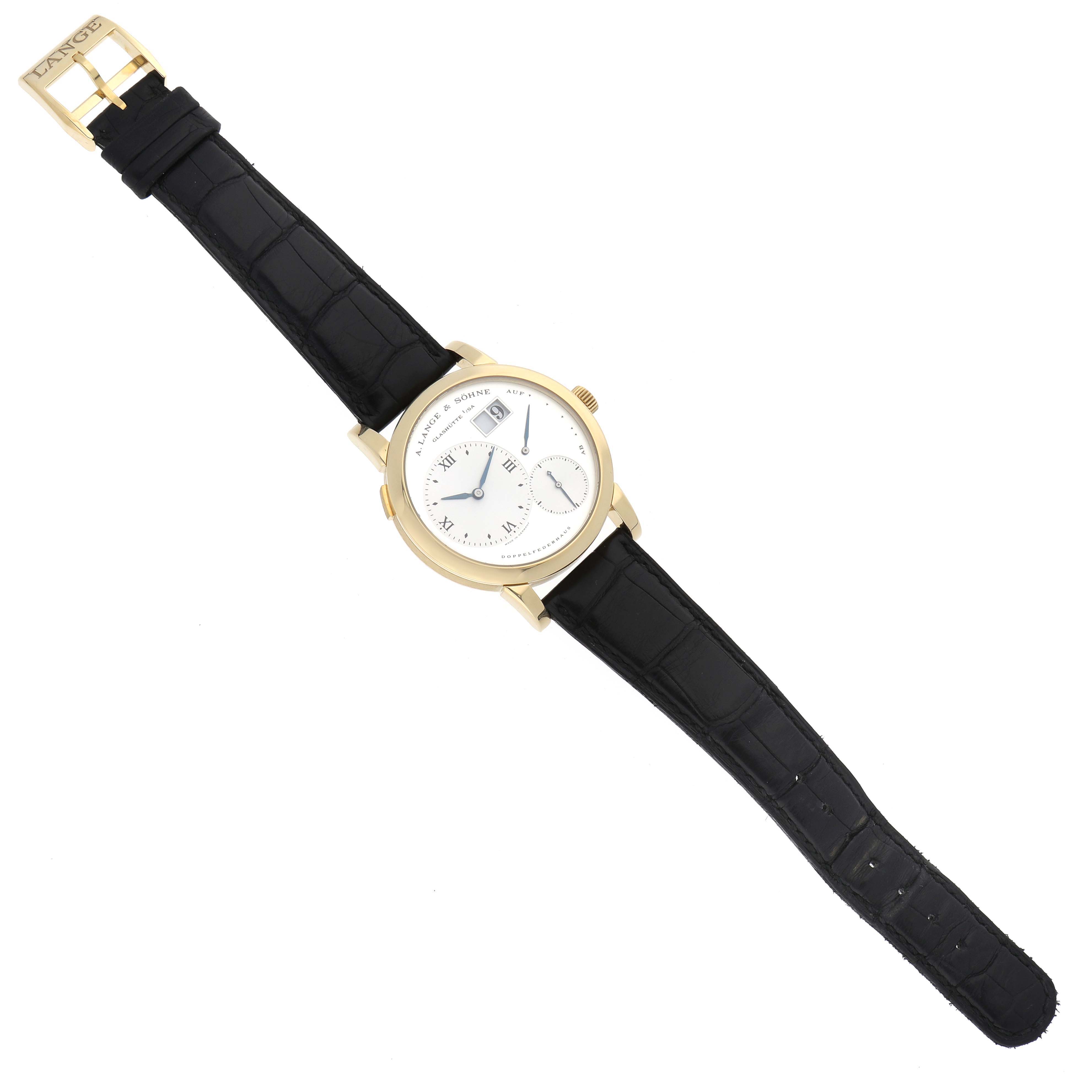 The image shows a full top-down view of the Lange 1 watch by A. Lange & Söhne, highlighting its dial and black leather strap.