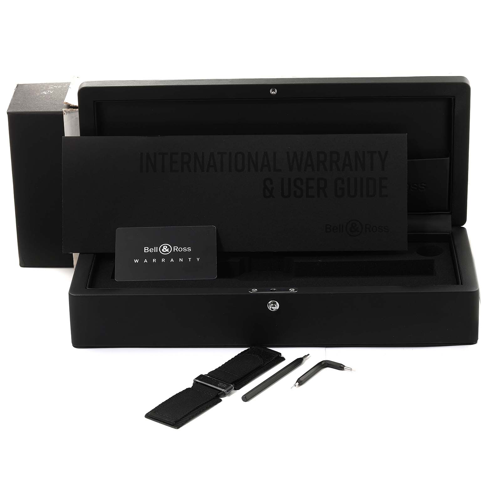 The image shows an open box of the Bell & Ross Instruments BR0392-BL-CE Men's Ceramic Black Dial BR0392-BL-CE Men's Ceramic Black Dial model watch, with an extra strap, tools, warranty card, and user guide booklet.