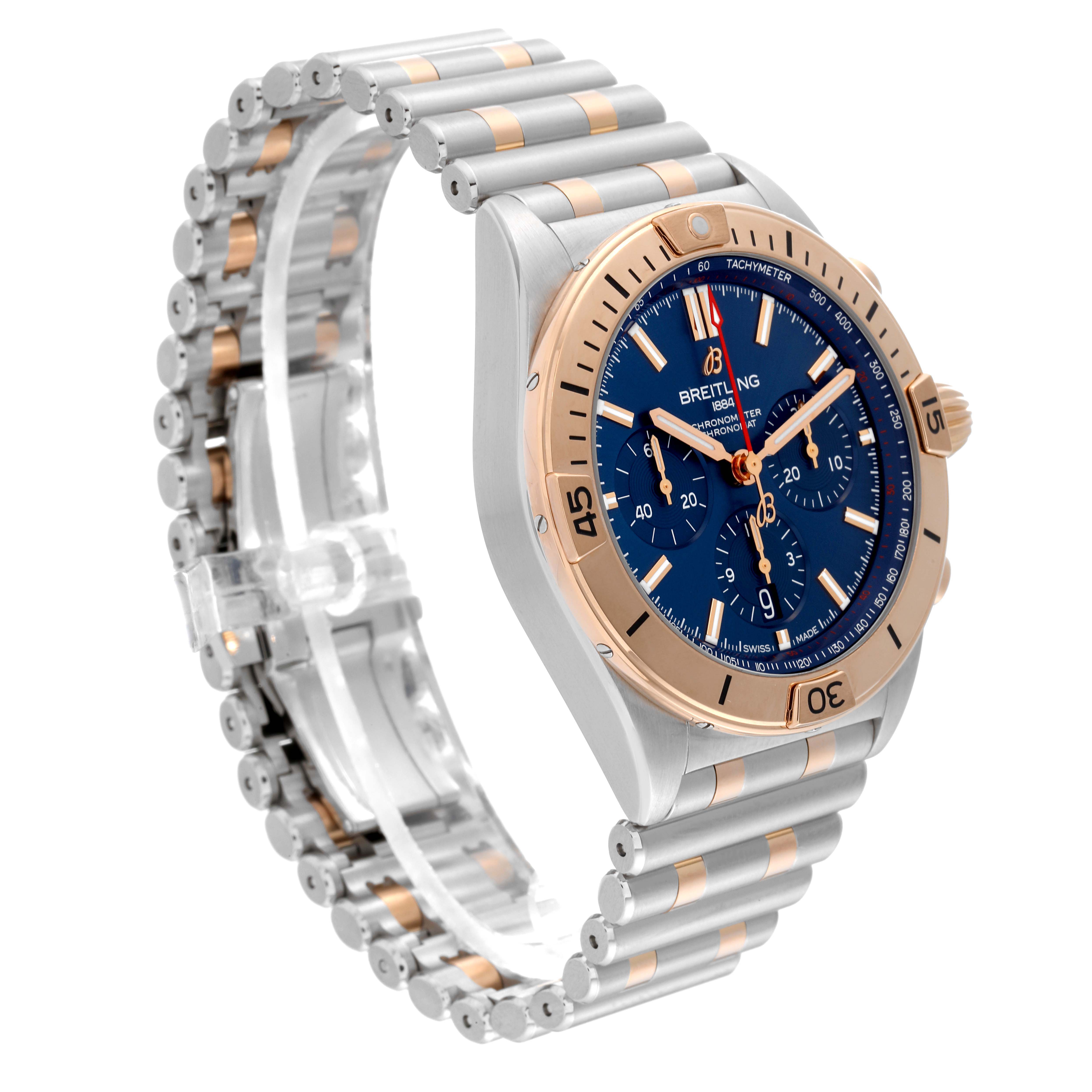 The image shows a side angle of the Breitling Chronomat UB0134101C1U1 Men's Steel and Gold (two tone) Blue Dial UB0134101C1U1 Men's Steel and Gold (two tone) Blue Dial watch, highlighting its blue dial, bezel, and metal bracelet.
