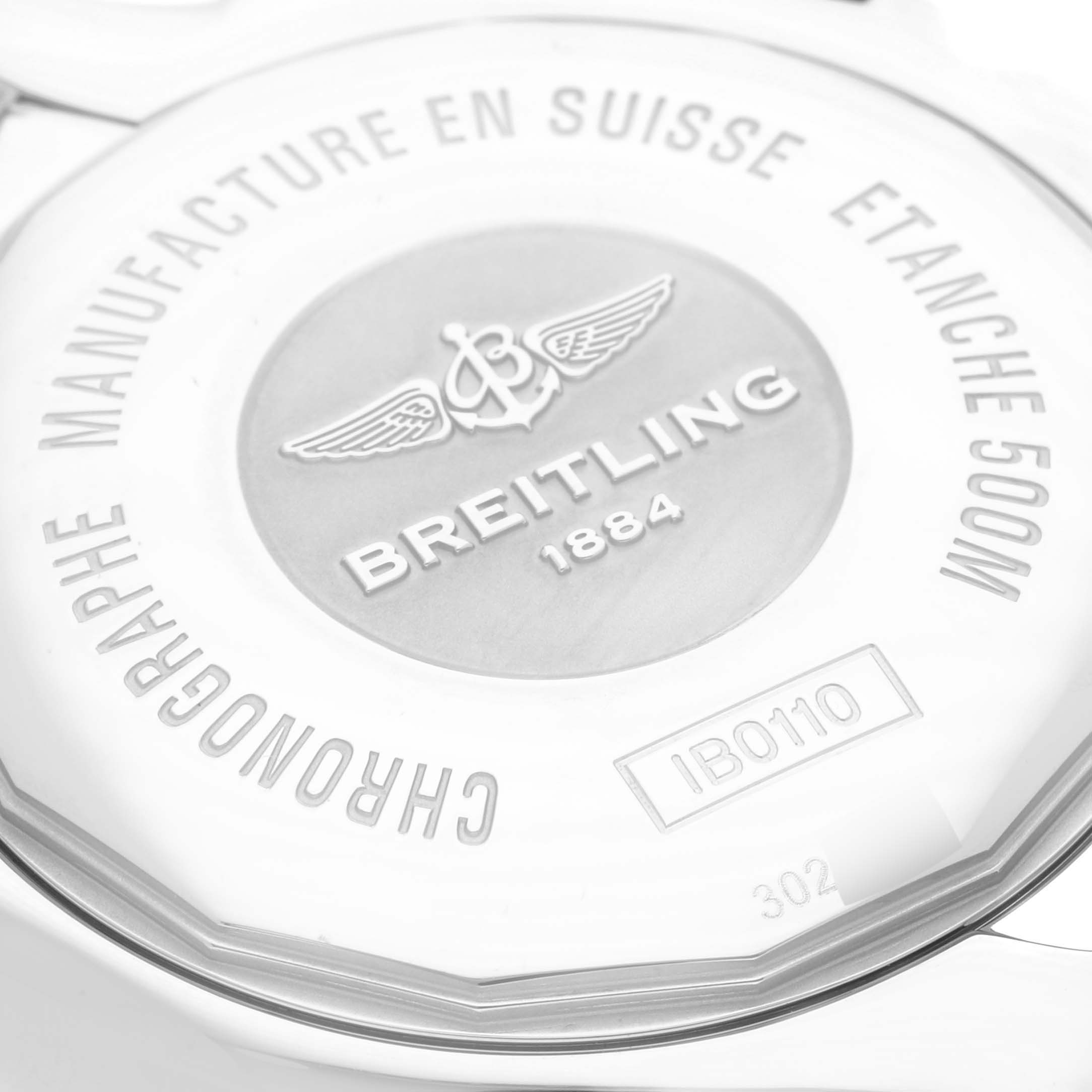 The image shows the back case of a Breitling Chronomat IB0110 Men's Stainless Steel White Dial IB0110 Men's Stainless Steel White Dial watch, highlighting its engravings and brand logo.