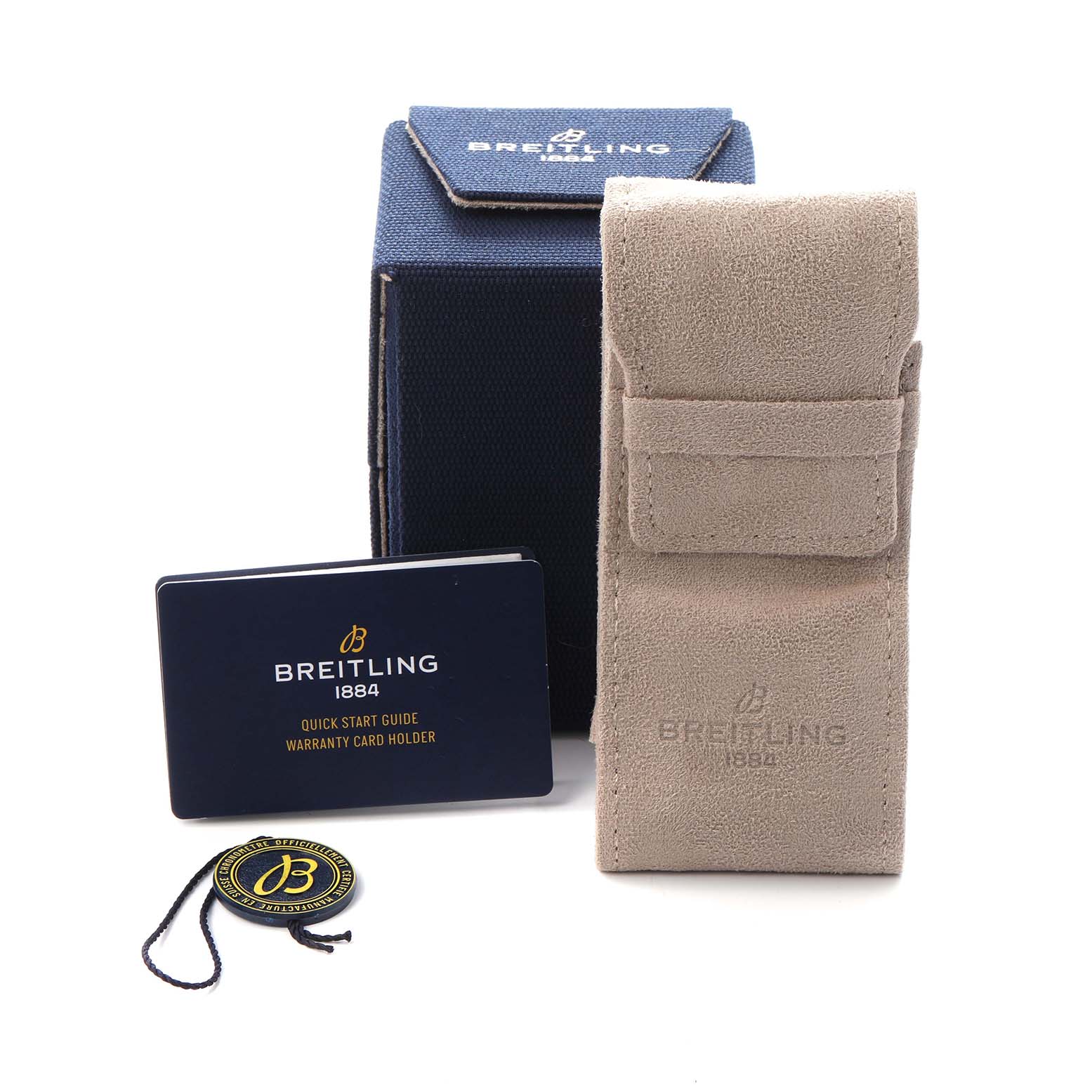 The image shows the packaging and accessories of a Breitling Aviator A23380 Men
s Stainless Steel Green Dial A23380 Men
s Stainless Steel Green Dial, including a box, pouch, warranty card holder, and tag.