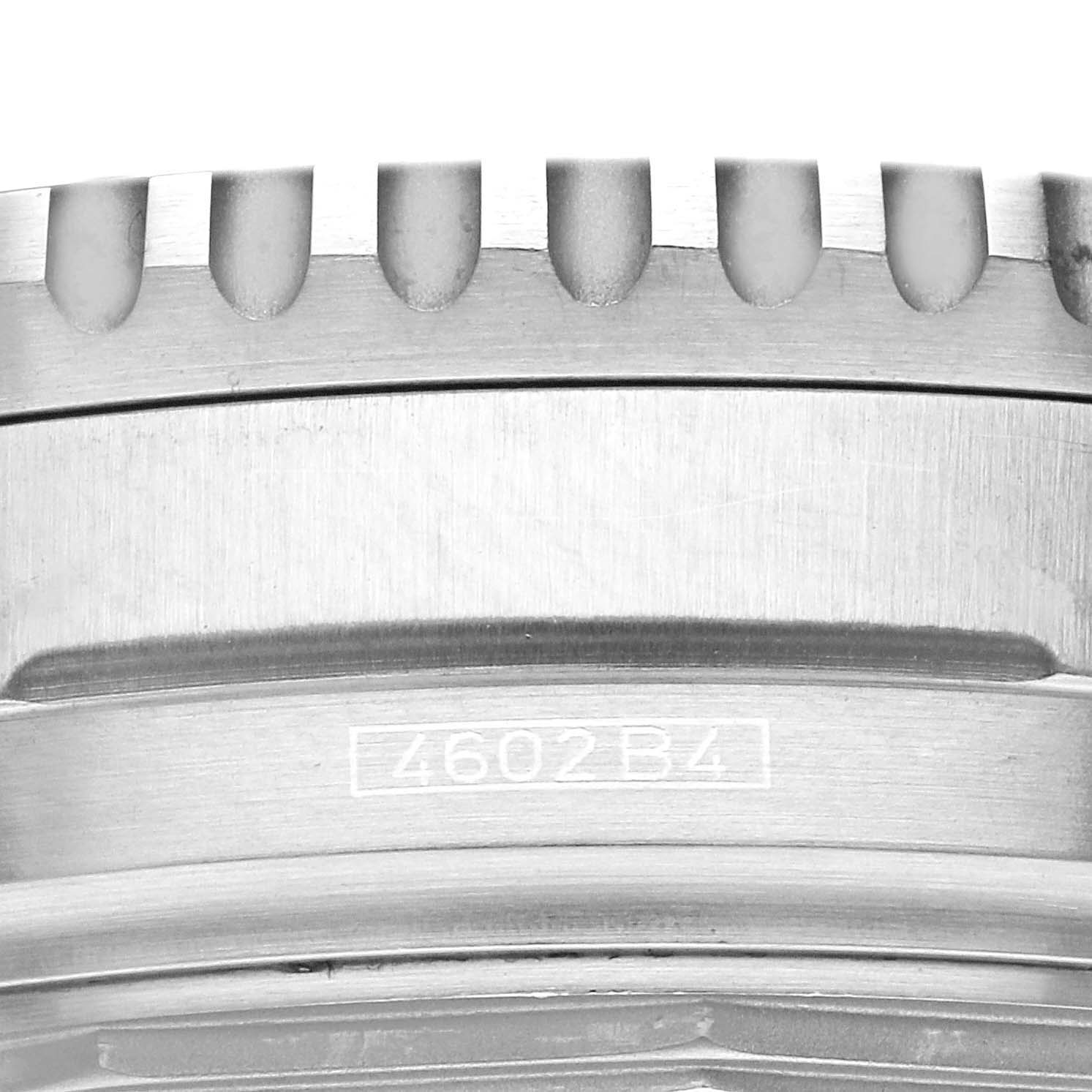This close-up image shows the bezel with its ridged edge and part of the case of the Breitling Navitimer A41322 Men's Stainless Steel Silver Dial A41322 Men's Stainless Steel Silver Dial watch, including a part number engraving.