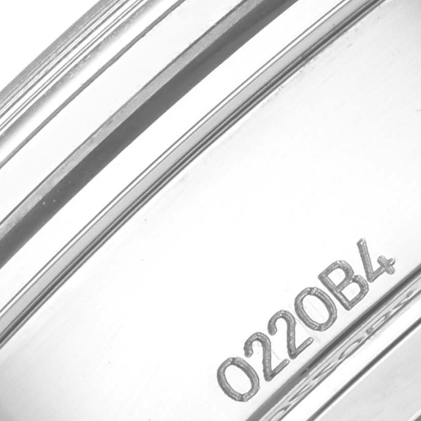 This close-up image shows the side of the Breitling Premier AB0118 Men's Stainless Steel Green Dial AB0118 Men's Stainless Steel Green Dial watch case, featuring its engraved model number.