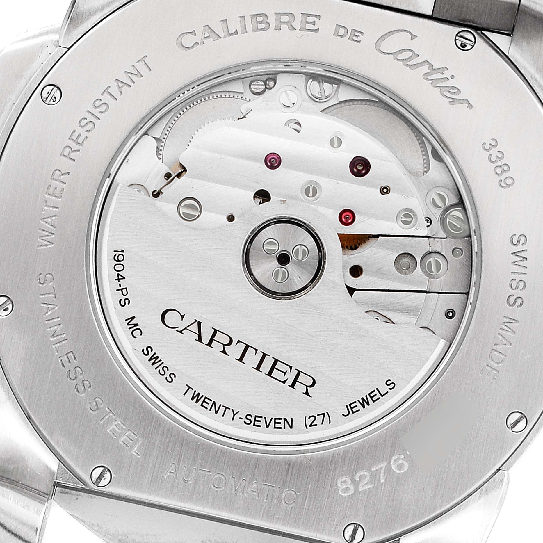 The image shows the rear view of the Calibre de Cartier watch by Cartier, highlighting its automatic movement and engravings.