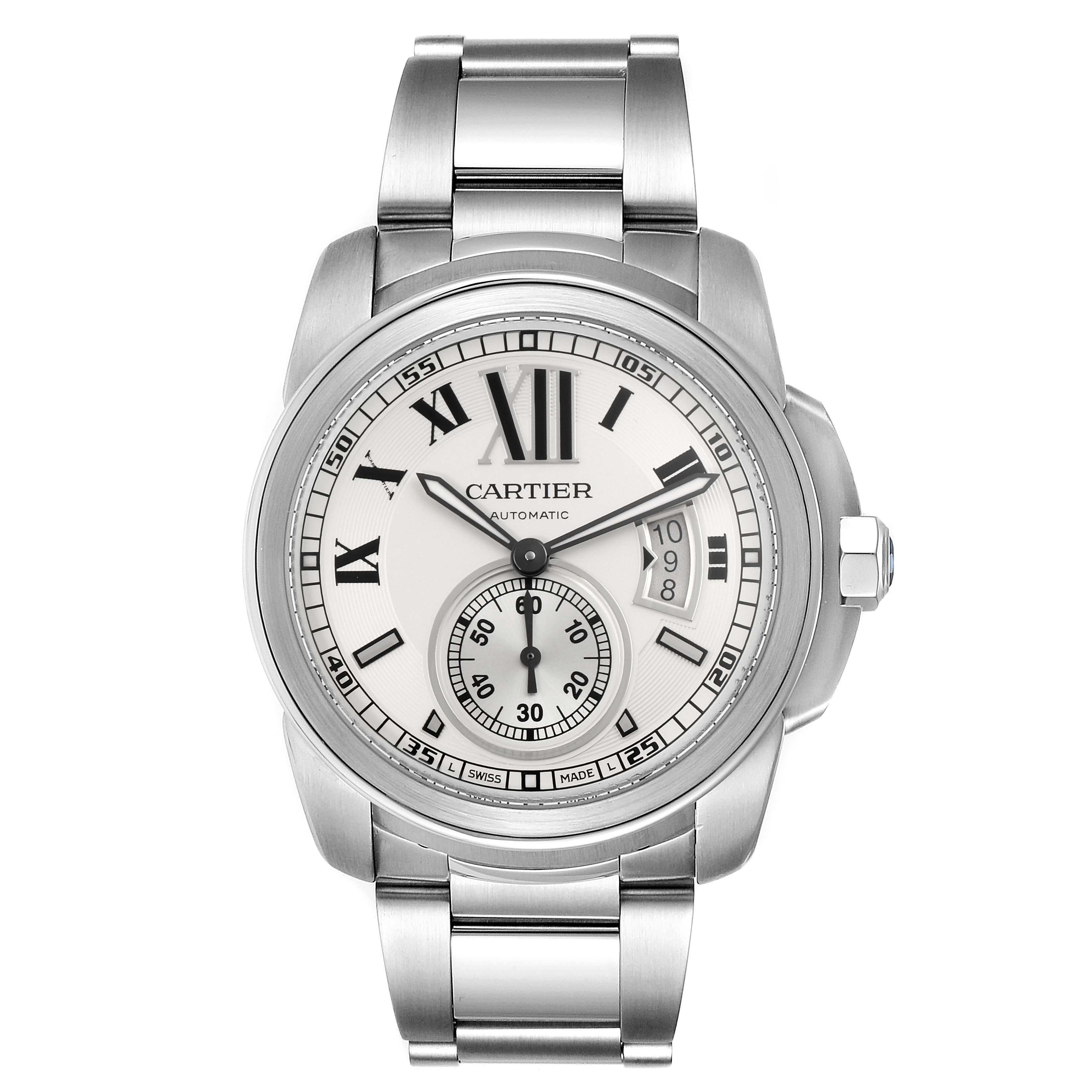 The image shows a front view of a Calibre de Cartier watch by Cartier, featuring its face, bezel, crown, and stainless steel bracelet.