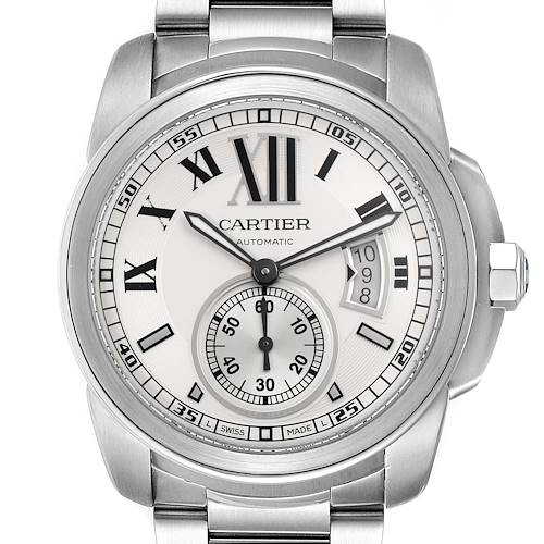 The Calibre de Cartier watch is shown from a front angle, displaying its dial, bezel, and part of the bracelet.