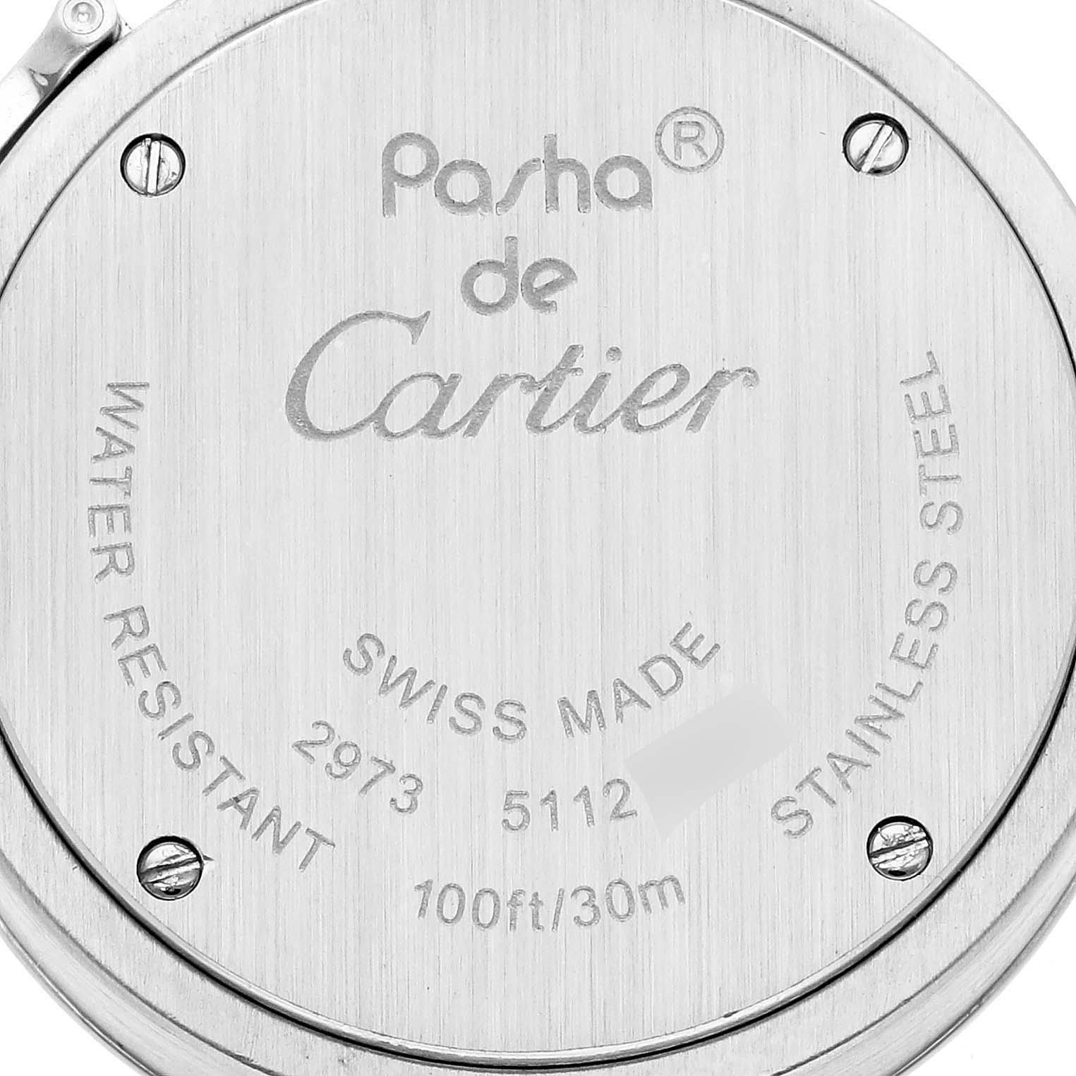 The image shows the back case of a Cartier Pasha W3140007 Women
s Stainless Steel Silver Dial W3140007 Women
s Stainless Steel Silver Dial watch, displaying engravings and screws.