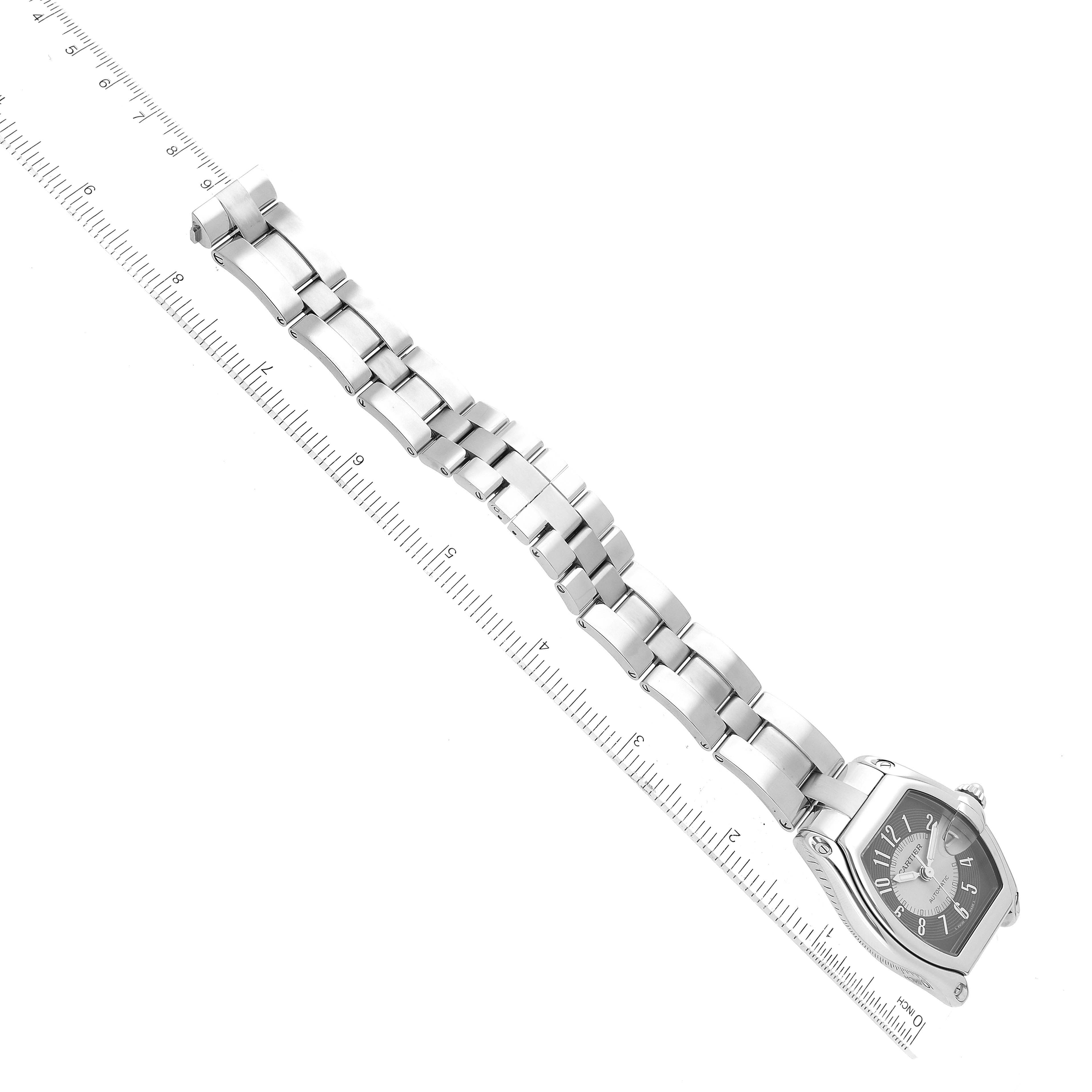 The image shows a Cartier Roadster W62001V3 Men's Stainless Steel Silver Dial W62001V3 Men's Stainless Steel Silver Dial watch laid flat, displaying the entire bracelet and face, with a ruler for scale.