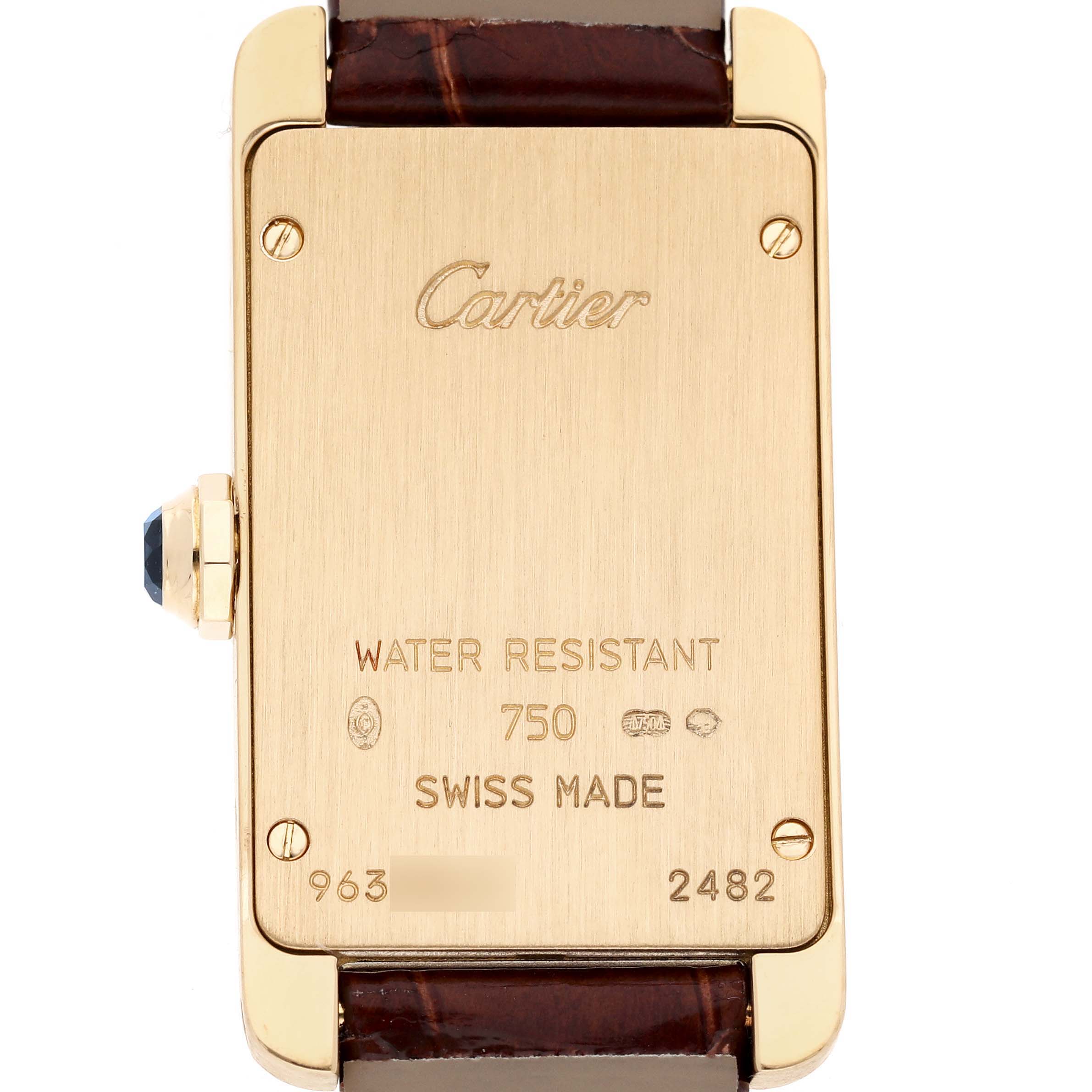 The image shows the back of a Cartier Tank Americaine W2601556 Women's Yellow Gold White Dial watch, highlighting inscriptions and a leather strap.
