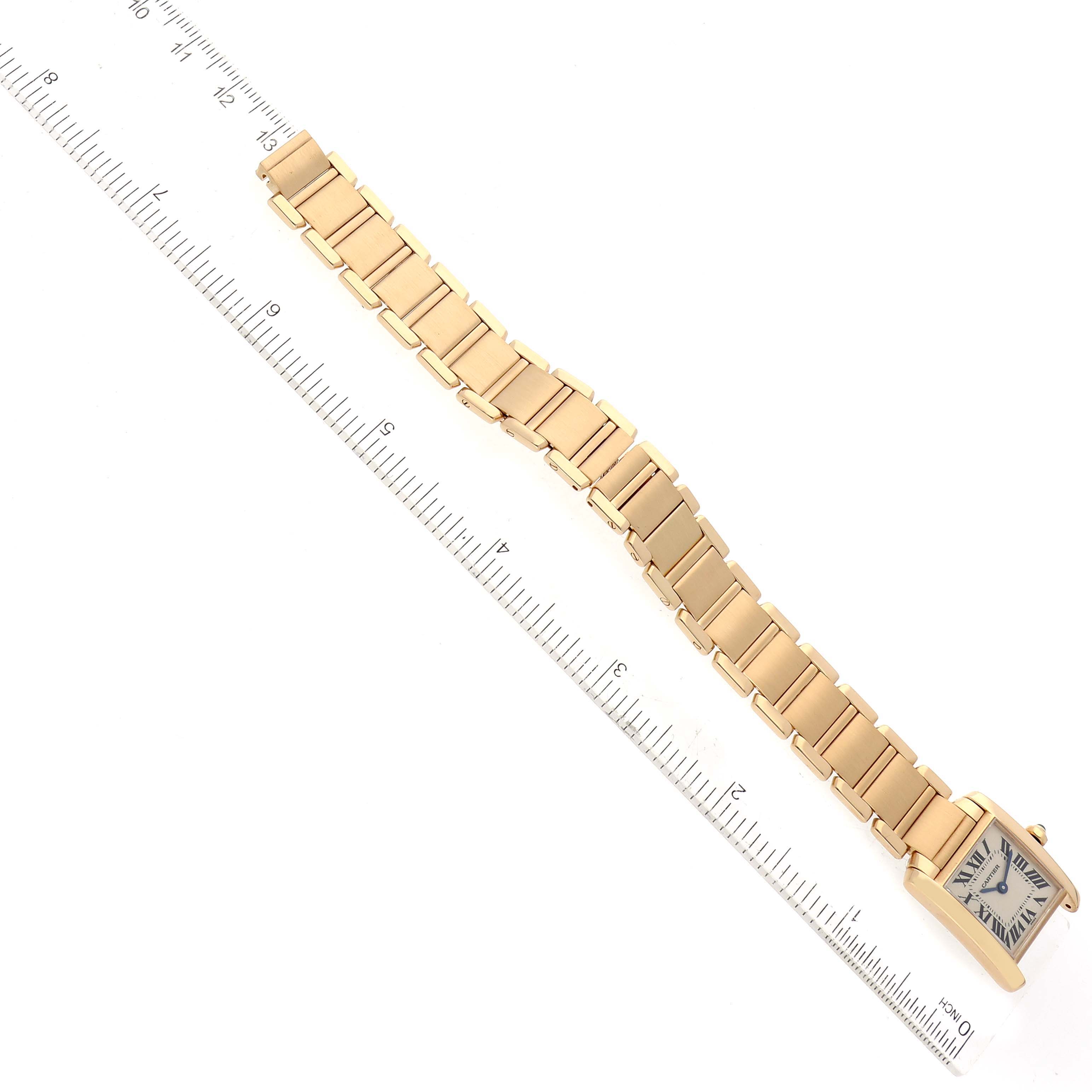 The image shows a Cartier Tank Francaise W50002N2 Women's Yellow Gold Silver Dial W50002N2 Women's Yellow Gold Silver Dial watch lying flat with a ruler for scale, displaying the full band and front view of the case.