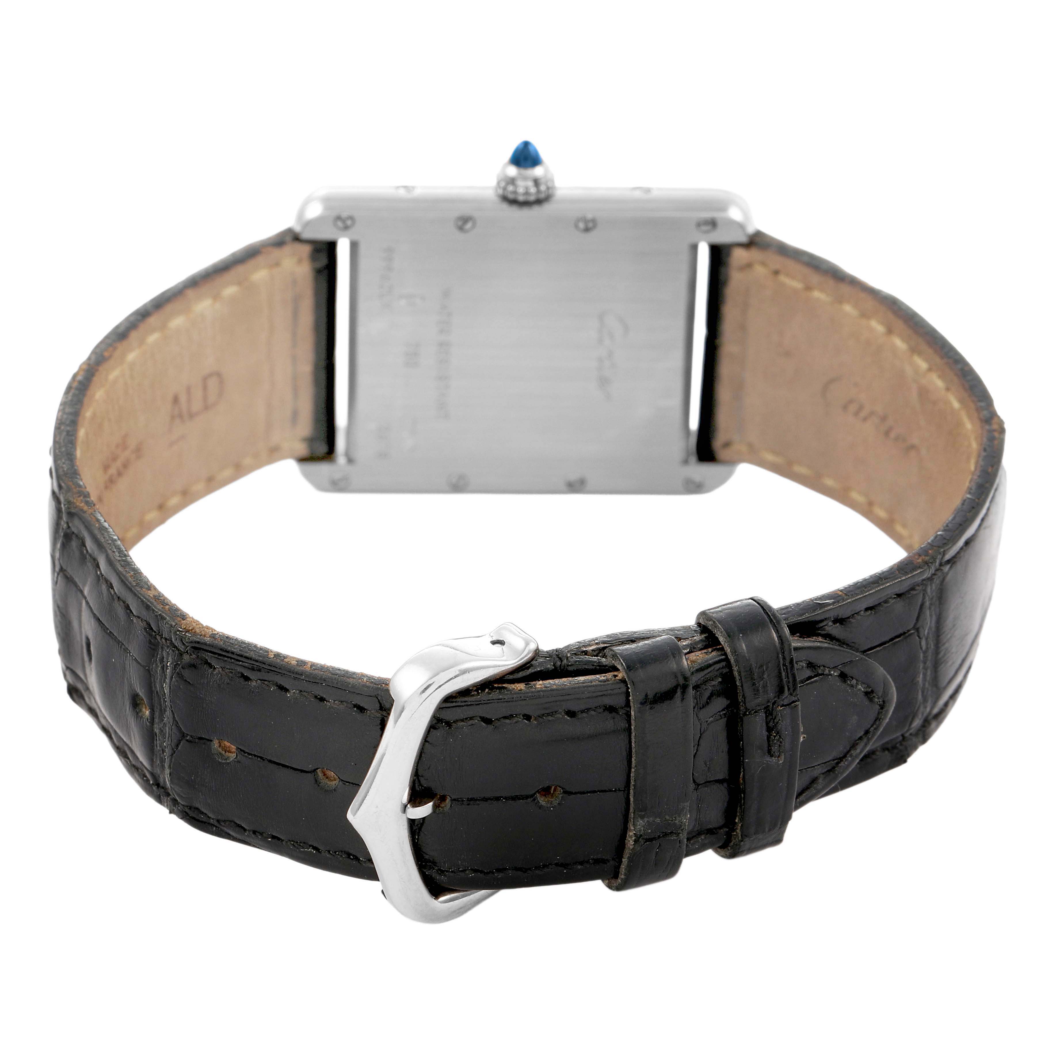 The image shows the back view of the Cartier Tank Louis W1540956 Men's Stainless Steel Silver Dial watch, highlighting the leather strap, buckle, and the watch's case back.