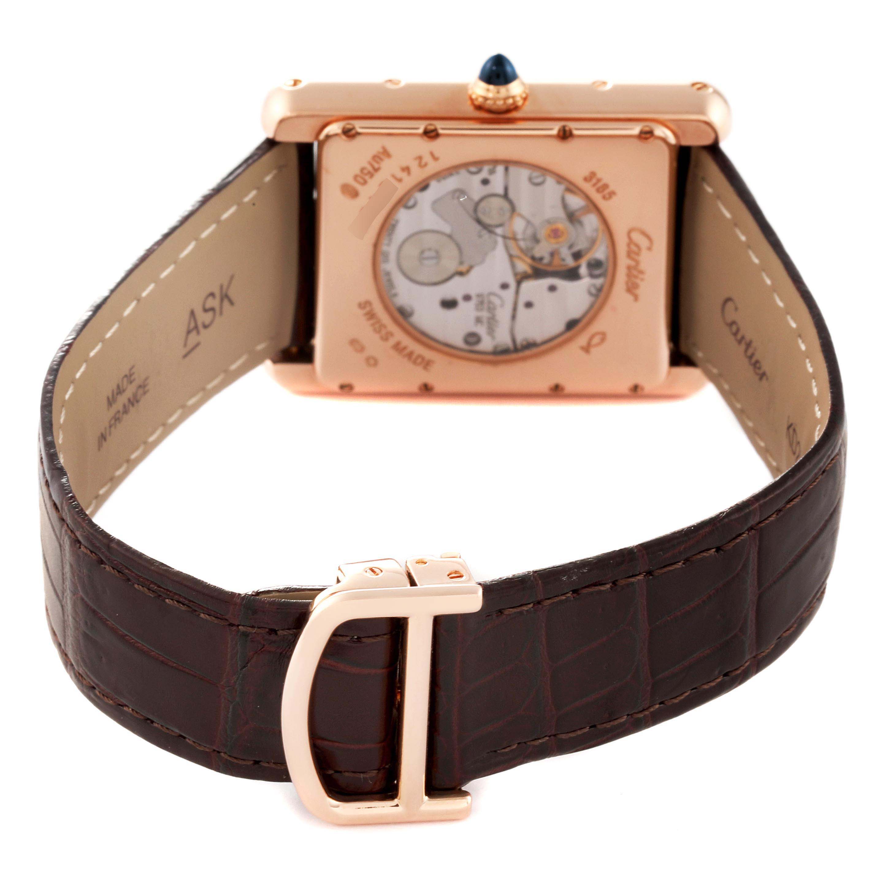 This image shows the back of a Cartier Tank Louis W1560003 Men's Rose Gold Silver Dial W1560003 Men's Rose Gold Silver Dial watch, highlighting its mechanical movement and brown leather strap with clasp.