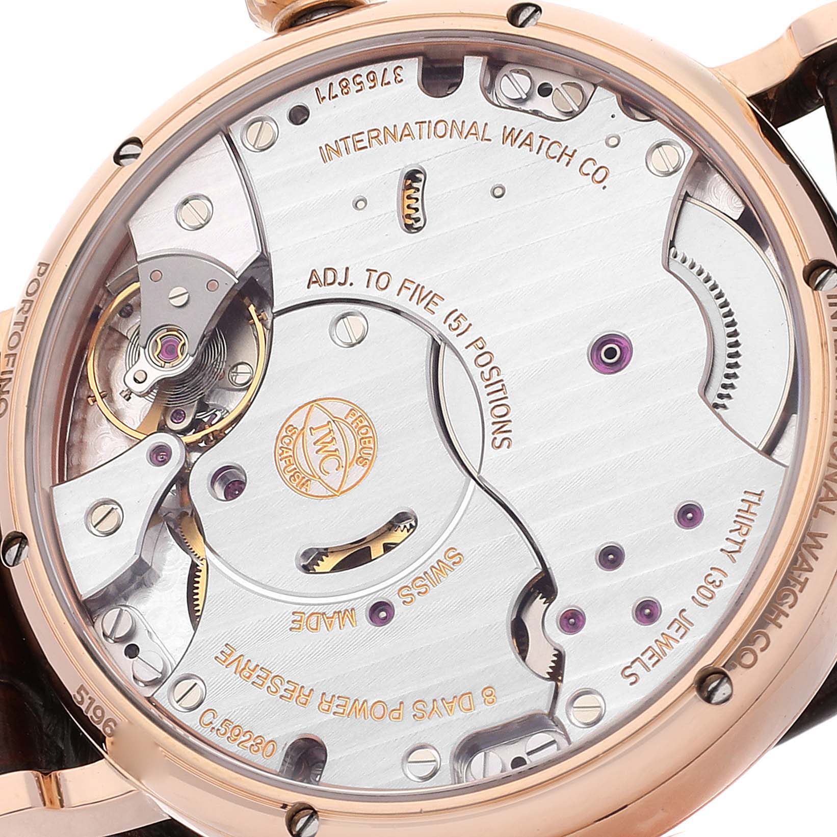 The image shows the back view of the IWC Portofino IW516102 Men's Rose Gold Silver Dial IW516102 Men's Rose Gold Silver Dial watch, displaying its inner mechanical components and engravings.