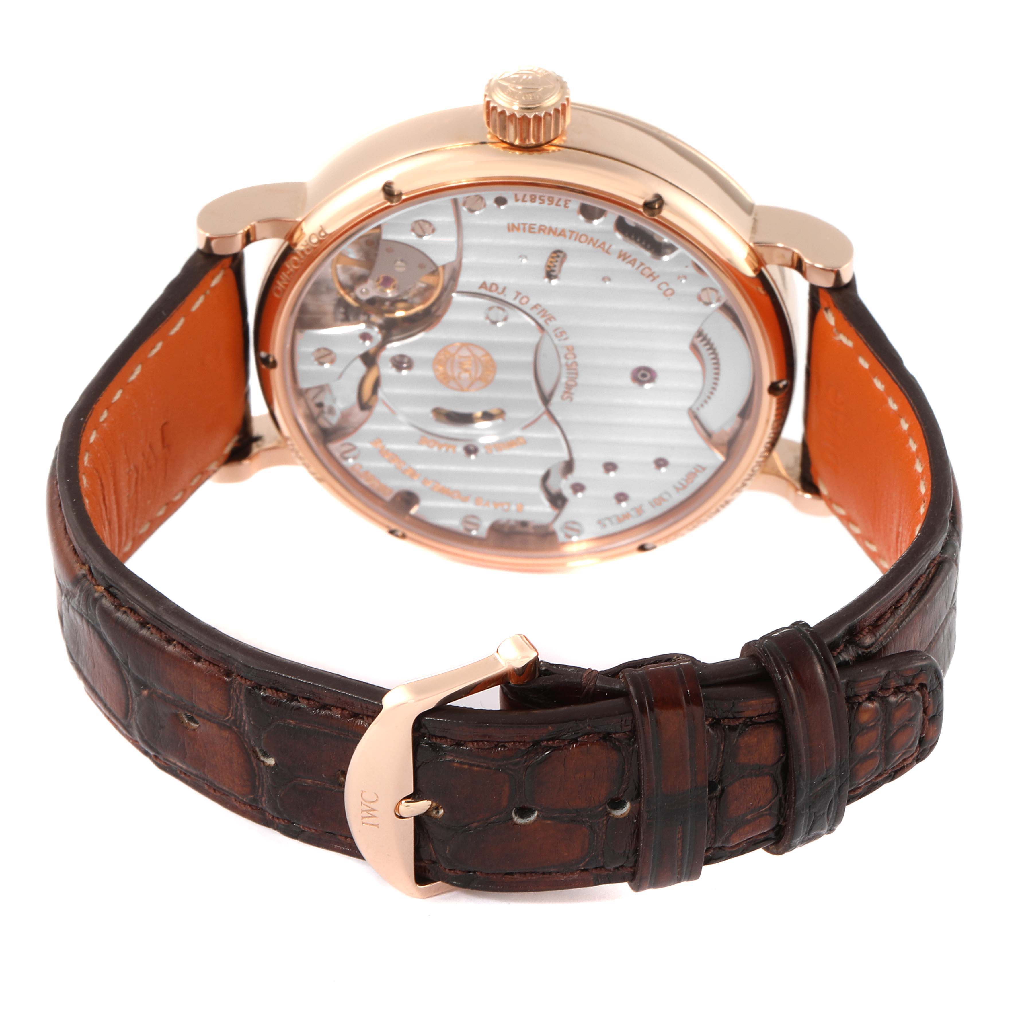 The image shows the back view of an IWC Portofino IW516102 Men's Rose Gold Silver Dial IW516102 Men's Rose Gold Silver Dial watch, highlighting its movement and brown leather strap.