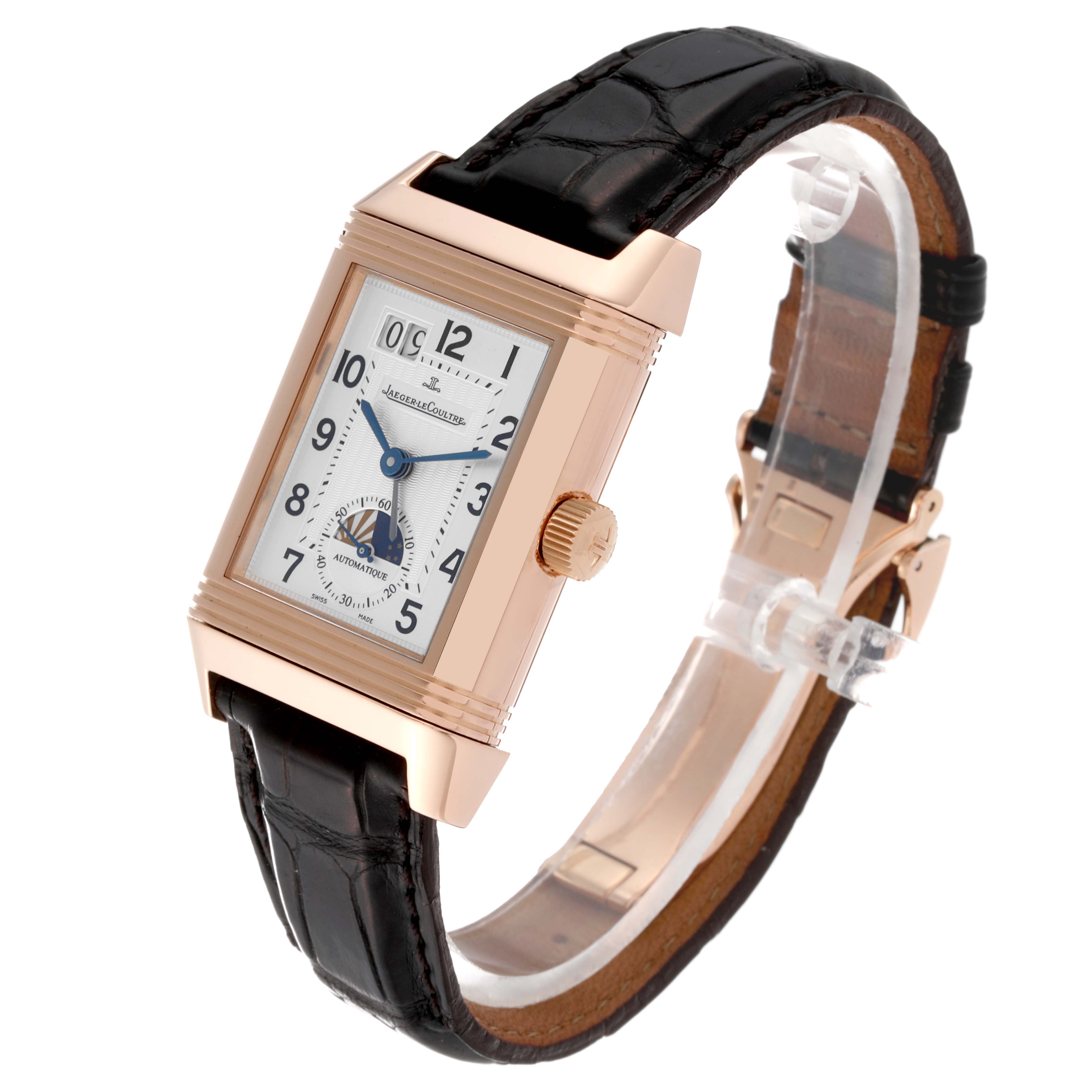 The Jaeger LeCoultre Reverso Q3032420 Men's Rose Gold Silver Dial Q3032420 Men's Rose Gold Silver Dial watch is shown at a slight angle, highlighting the face, crown, and leather strap.