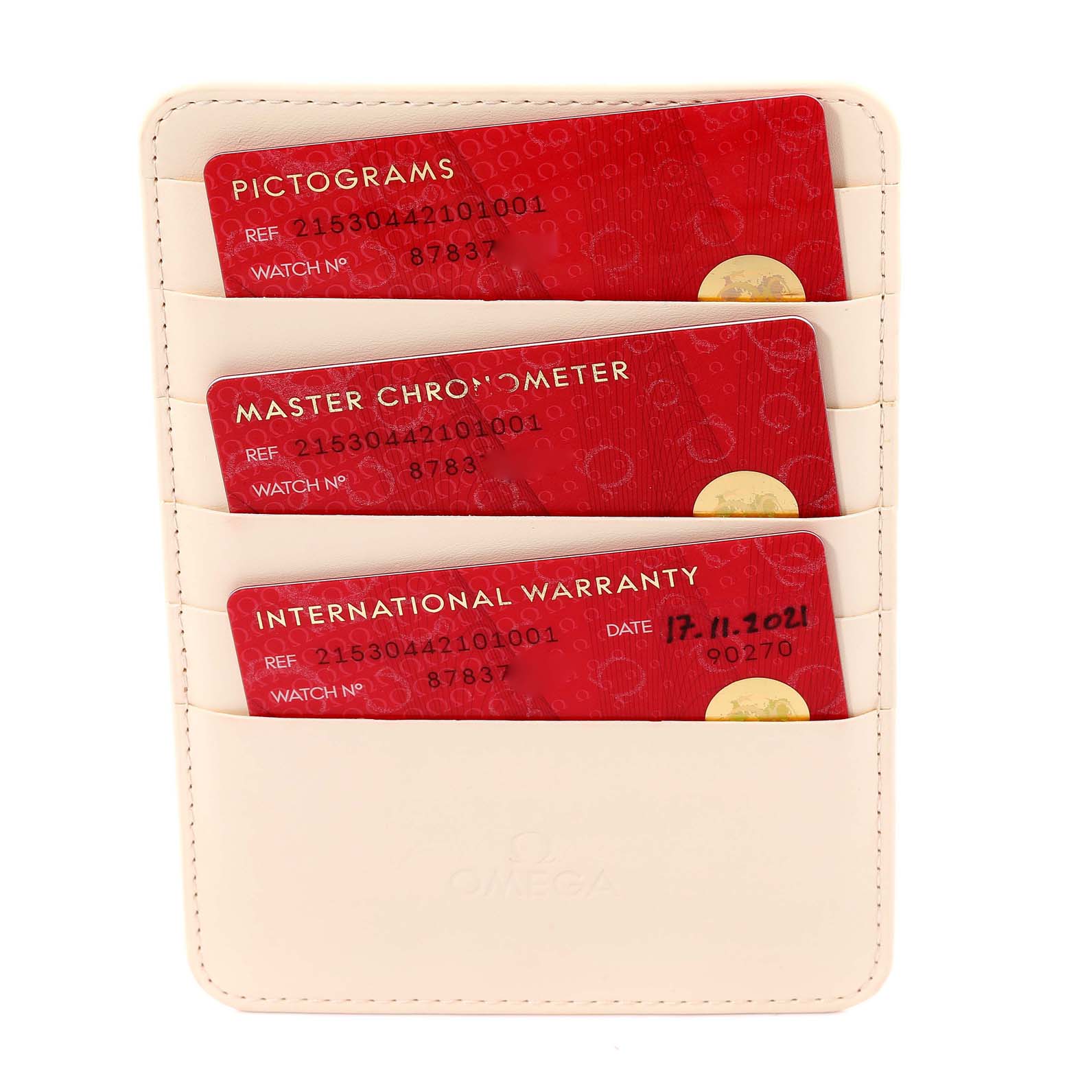 The image shows the warranty card holder with three red cards for the Omega Planet Ocean 215.30.44.21.01.001 Men
s Stainless Steel Black Dial 215.30.44.21.01.001 Men
s Stainless Steel Black Dial watch model, taken from a top-down angle.