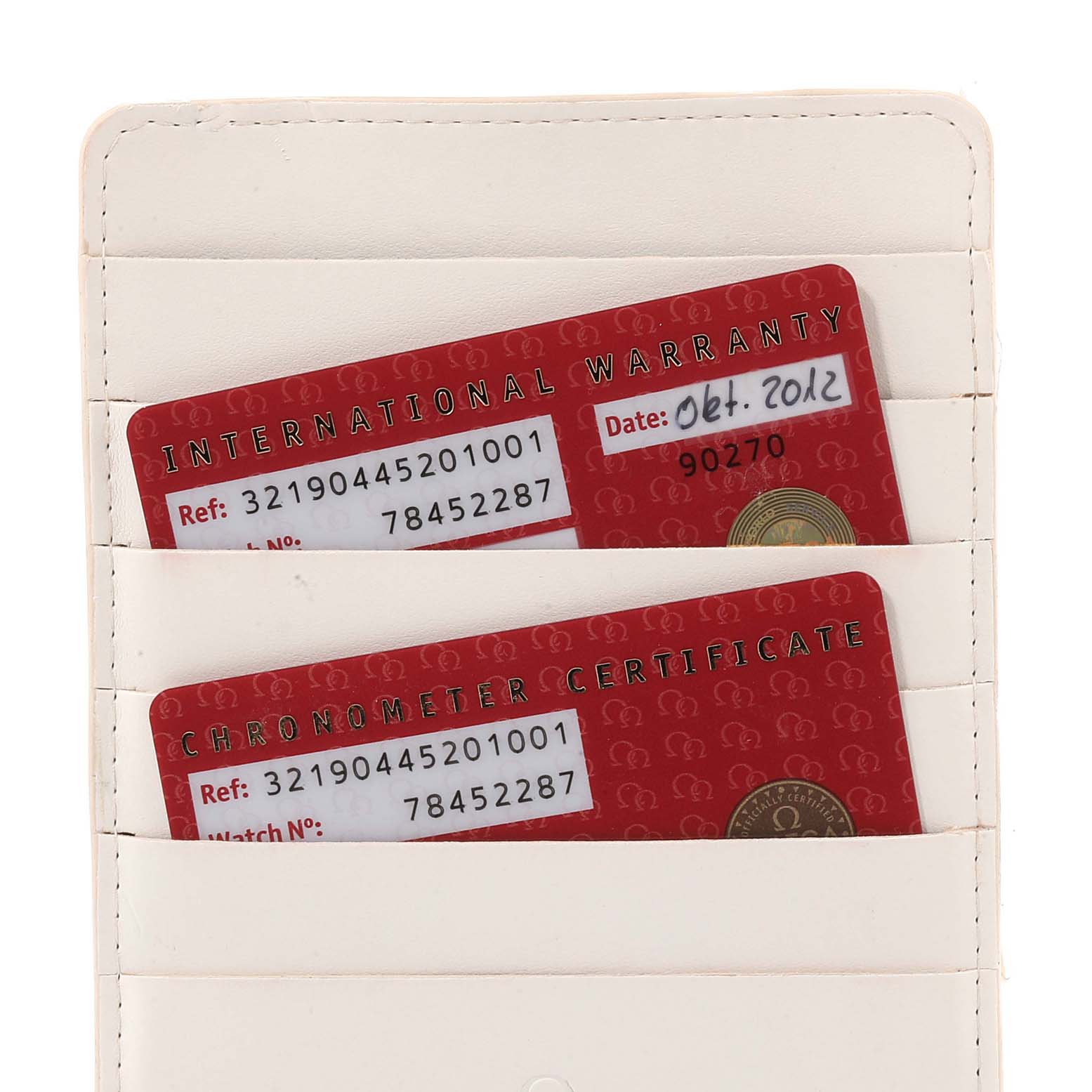 The image shows warranty and chronometer certificate cards for the Omega Speedmaster 321.90.44.52.01.001 Men's Titanium Black Dial 321.90.44.52.01.001 Men's Titanium Black Dial watch in a white cardholder.