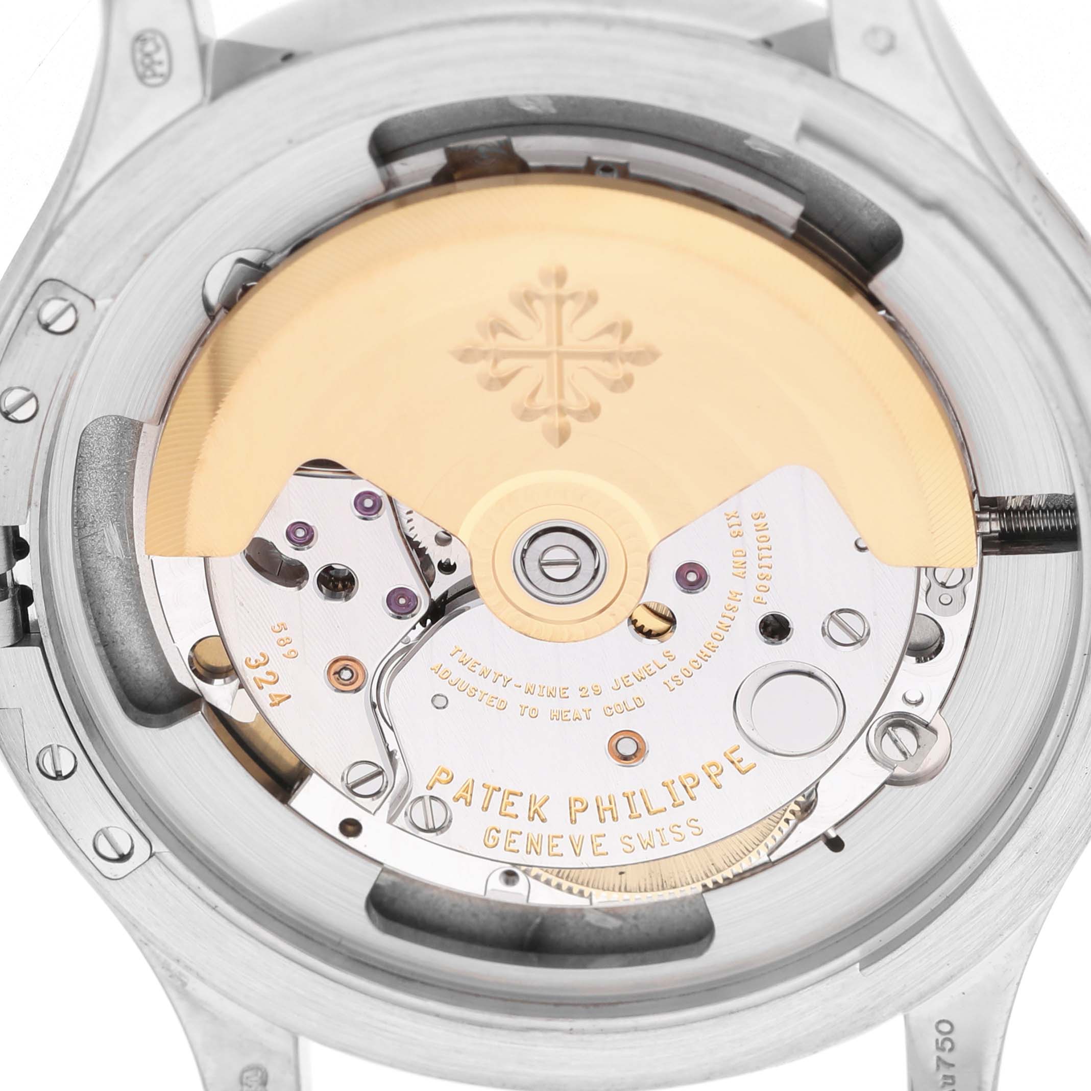 The image shows a close-up of the movement in a Patek Philippe Calatrava 5227G-010 Men's White Gold Black Dial, highlighting its intricate mechanical parts and rotor.