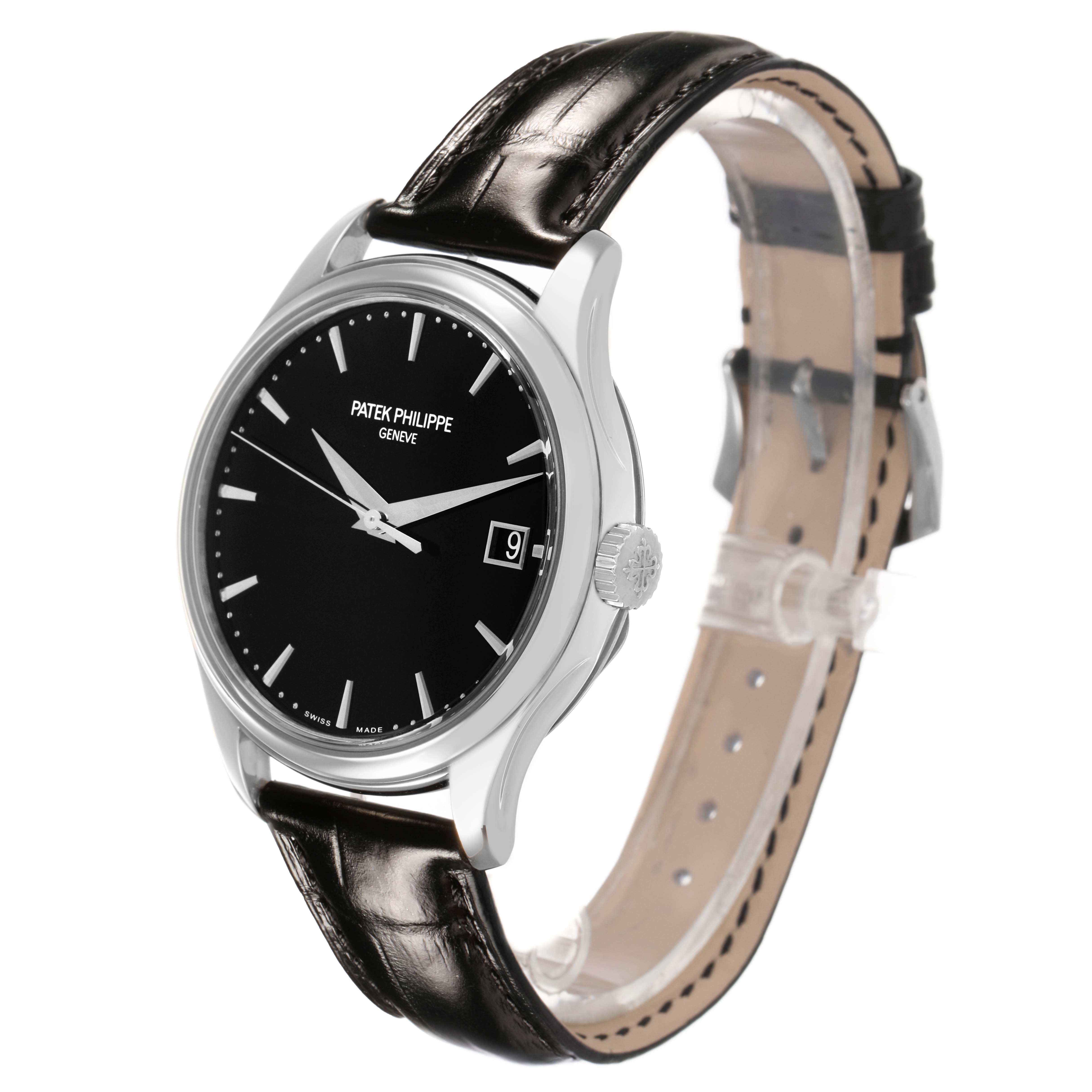 The Patek Philippe Calatrava 5227G-010 Men's White Gold Black Dial watch is shown at an angled side view, highlighting the dial, crown, and leather strap.