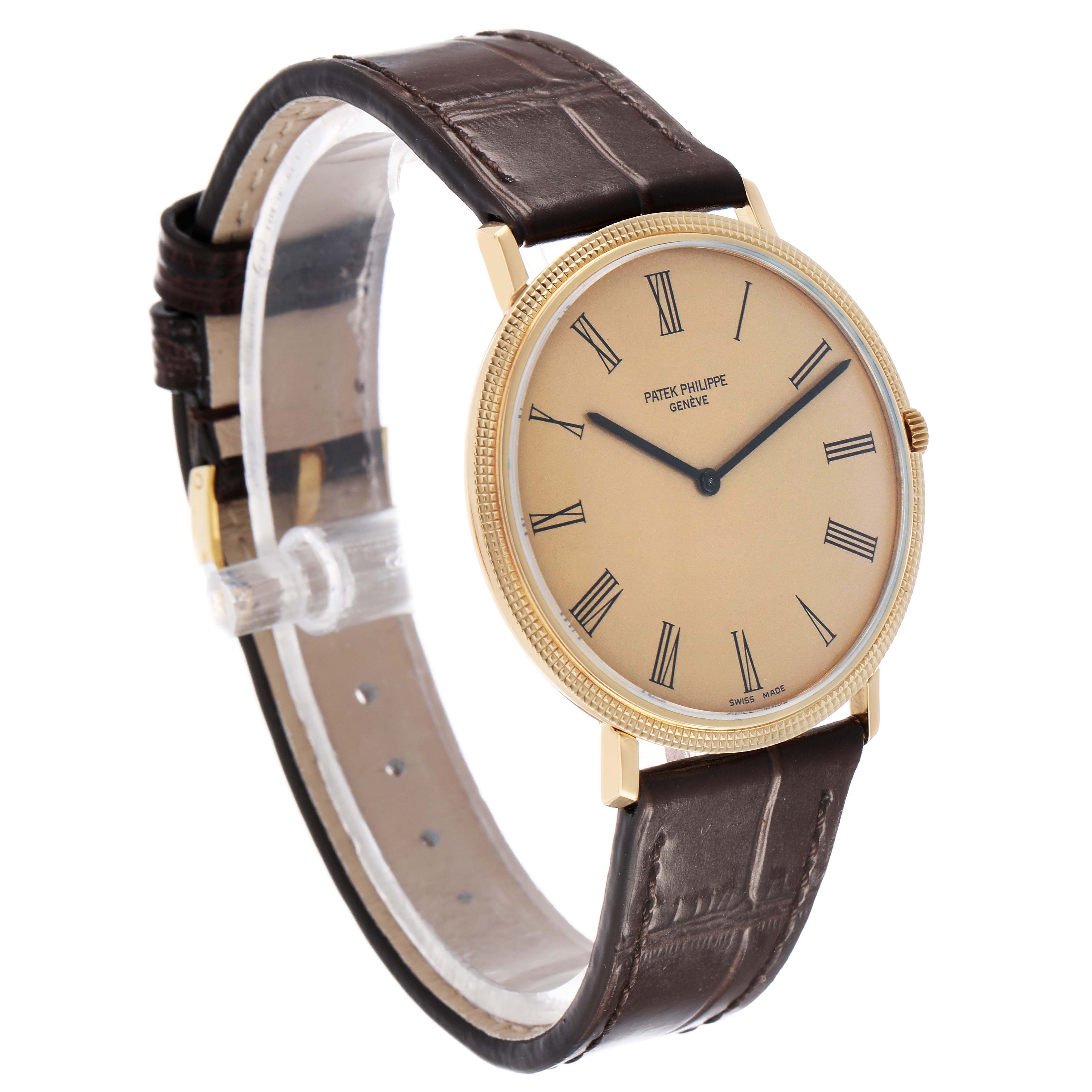 The Patek Philippe Calatrava 3588J Men's Yellow Gold Beige Dial watch is shown at a three-quarter angle, displaying the face, gold case, and brown leather strap.