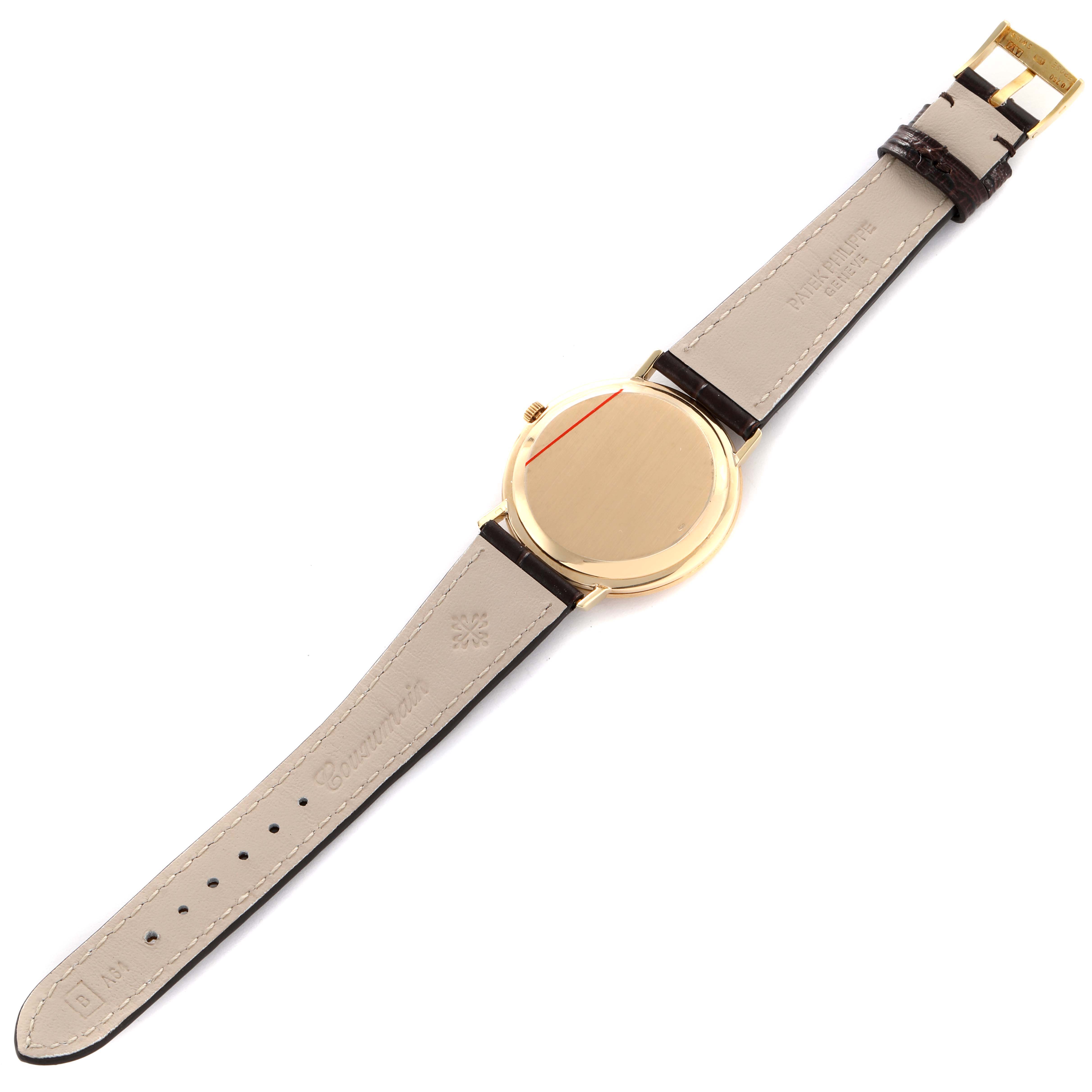 The Patek Philippe Calatrava 3588J Men's Yellow Gold Beige Dial watch is shown from the back, highlighting the case, crown, and leather strap.