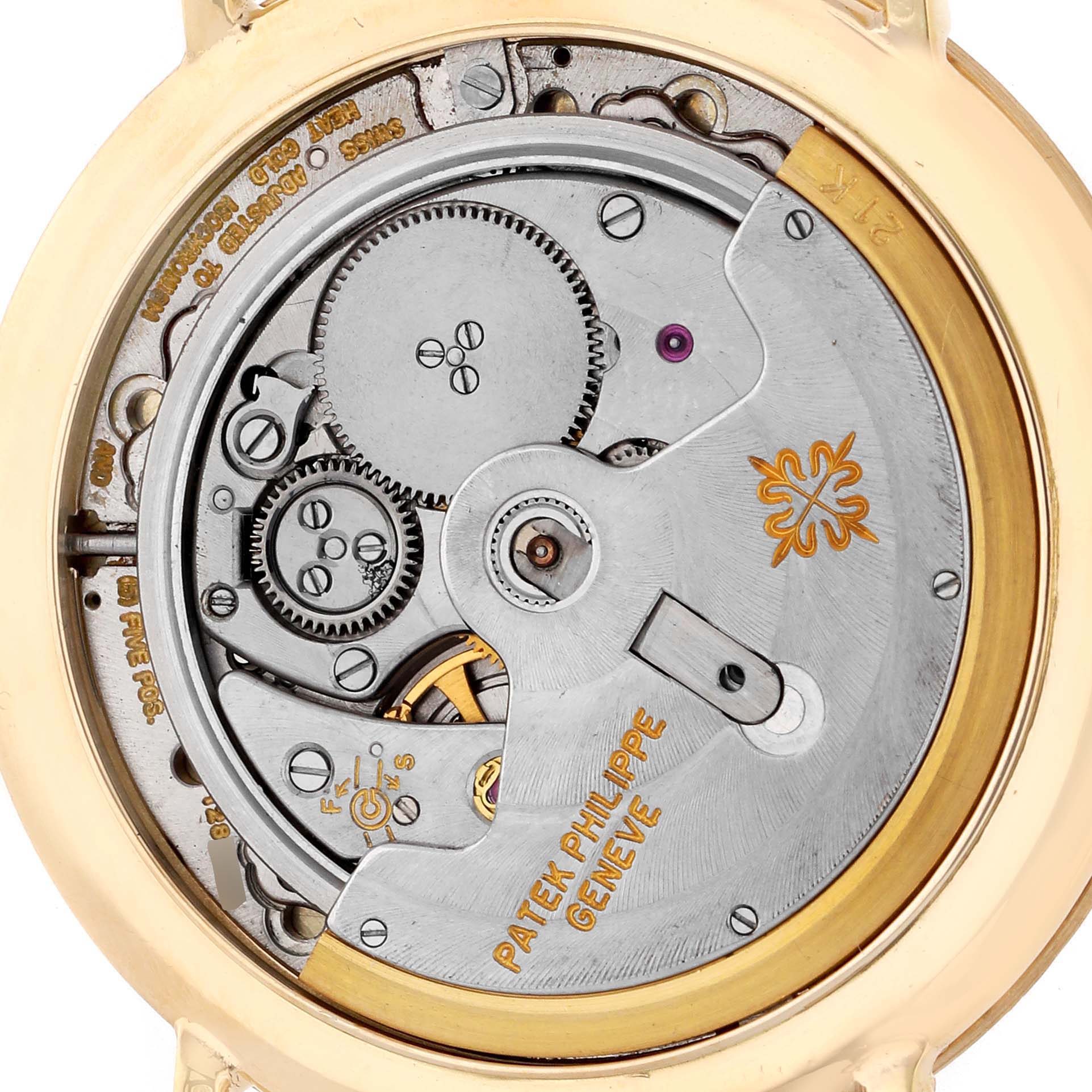 The image shows the movement and inner workings of a Patek Philippe Calatrava 3588J Men's Yellow Gold Beige Dial watch from a back view angle.