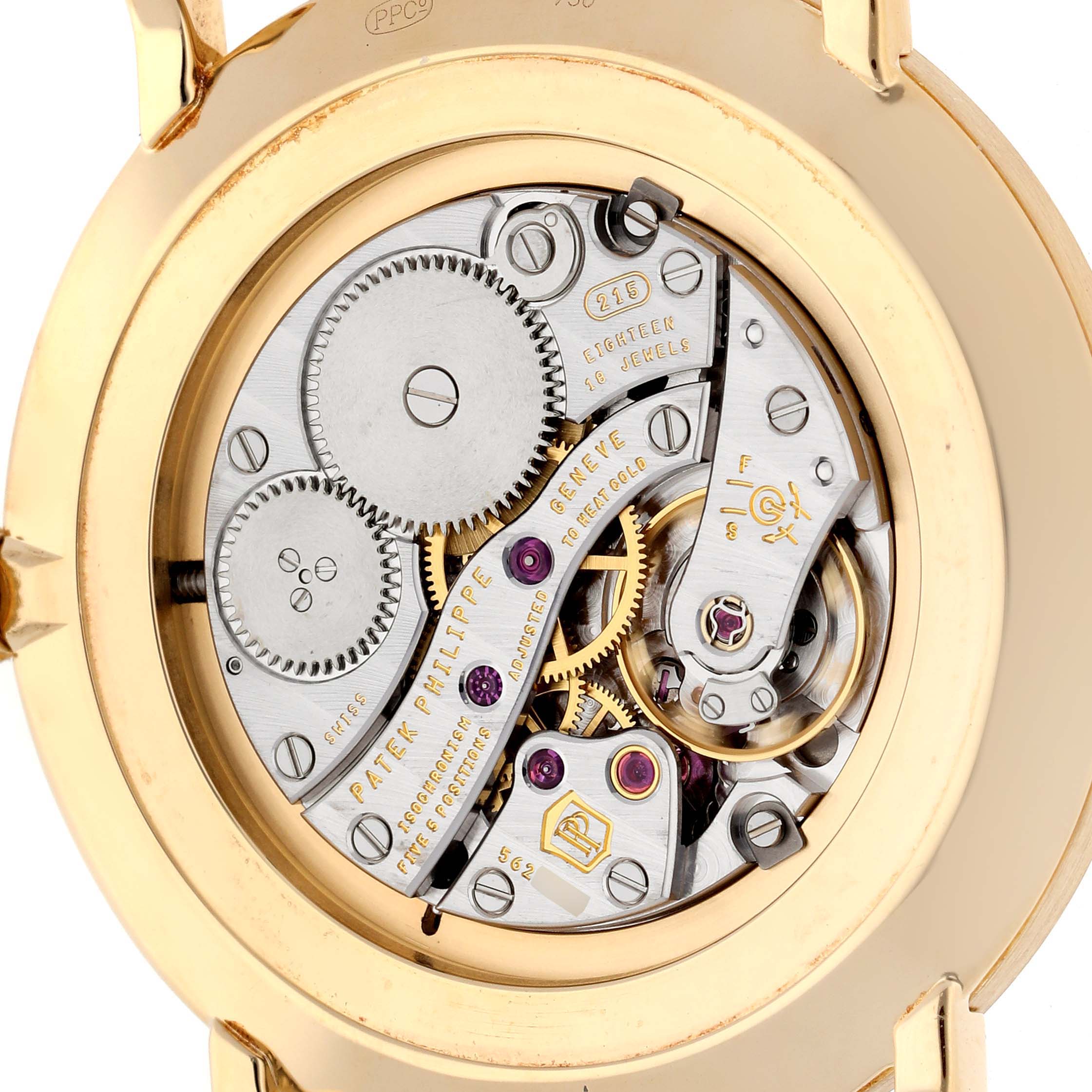 The image shows the back of a Calatrava model by Patek Philippe, revealing its intricate movement and gears.