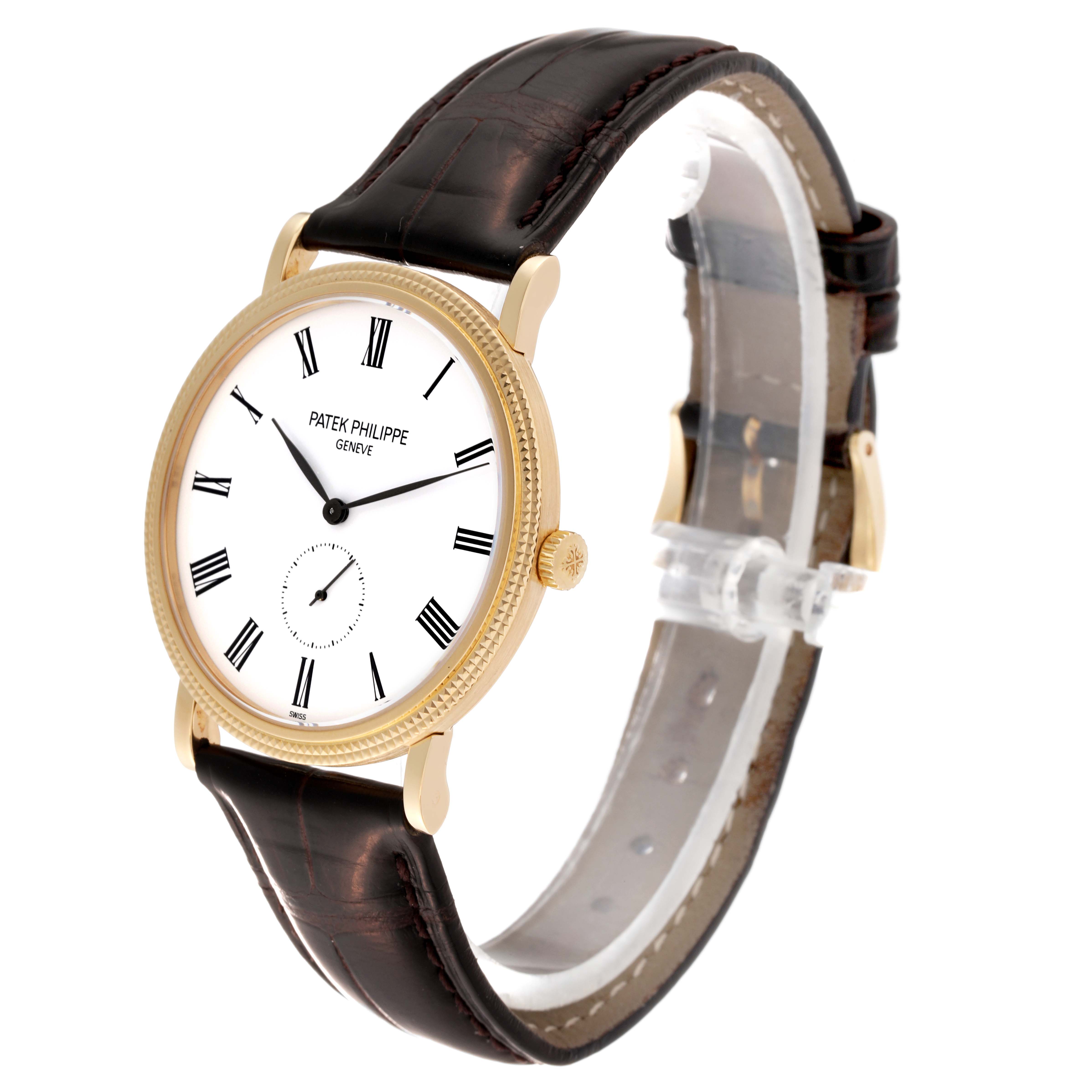 The Patek Philippe Calatrava 5119J Men's Yellow Gold White Dial 5119J Men's Yellow Gold White Dial watch is shown at a side angle, displaying the face, crown, strap, and bezel.