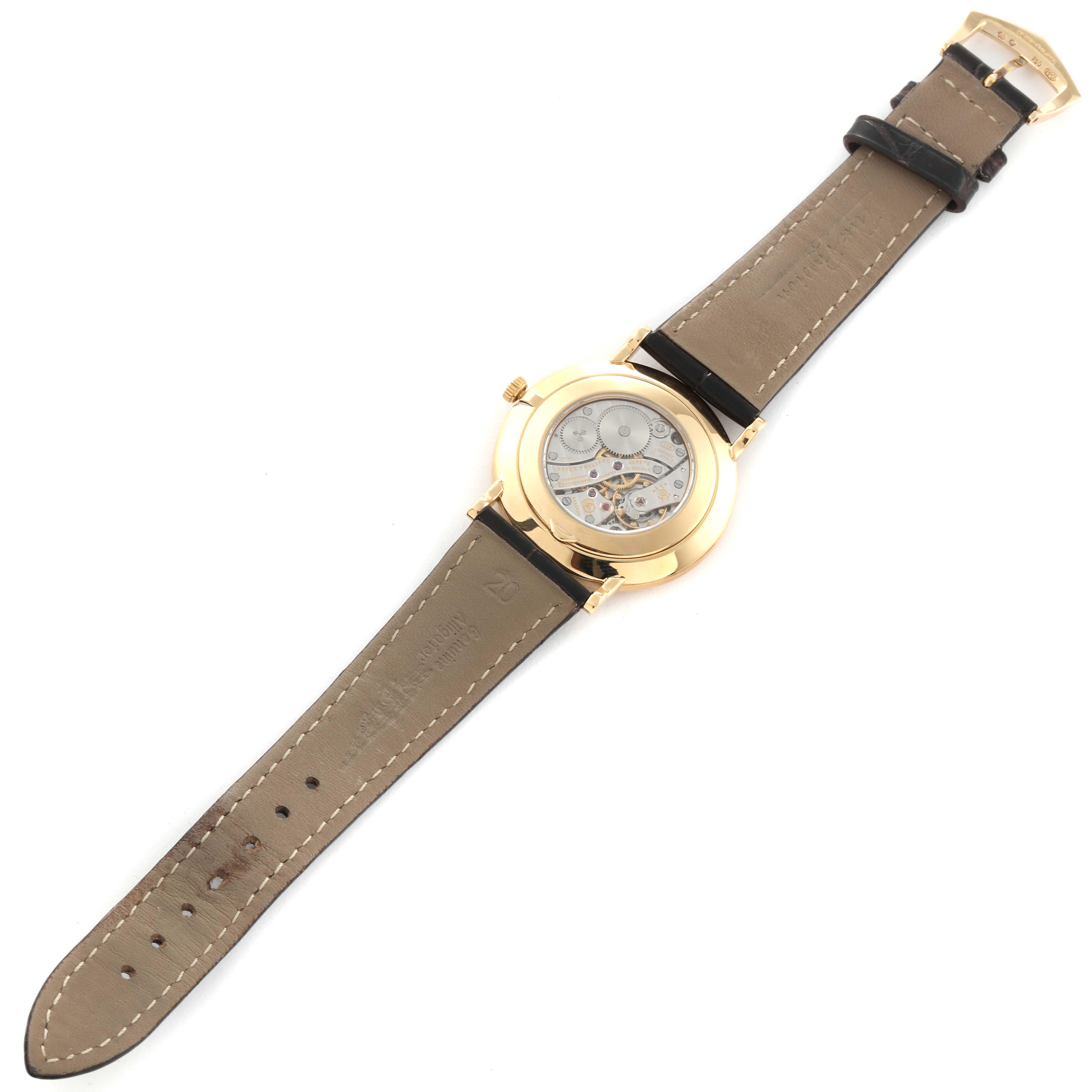 This image shows the back of a Patek Philippe Calatrava 5119J Men's Yellow Gold White Dial 5119J Men's Yellow Gold White Dial watch, highlighting its caseback and leather strap.