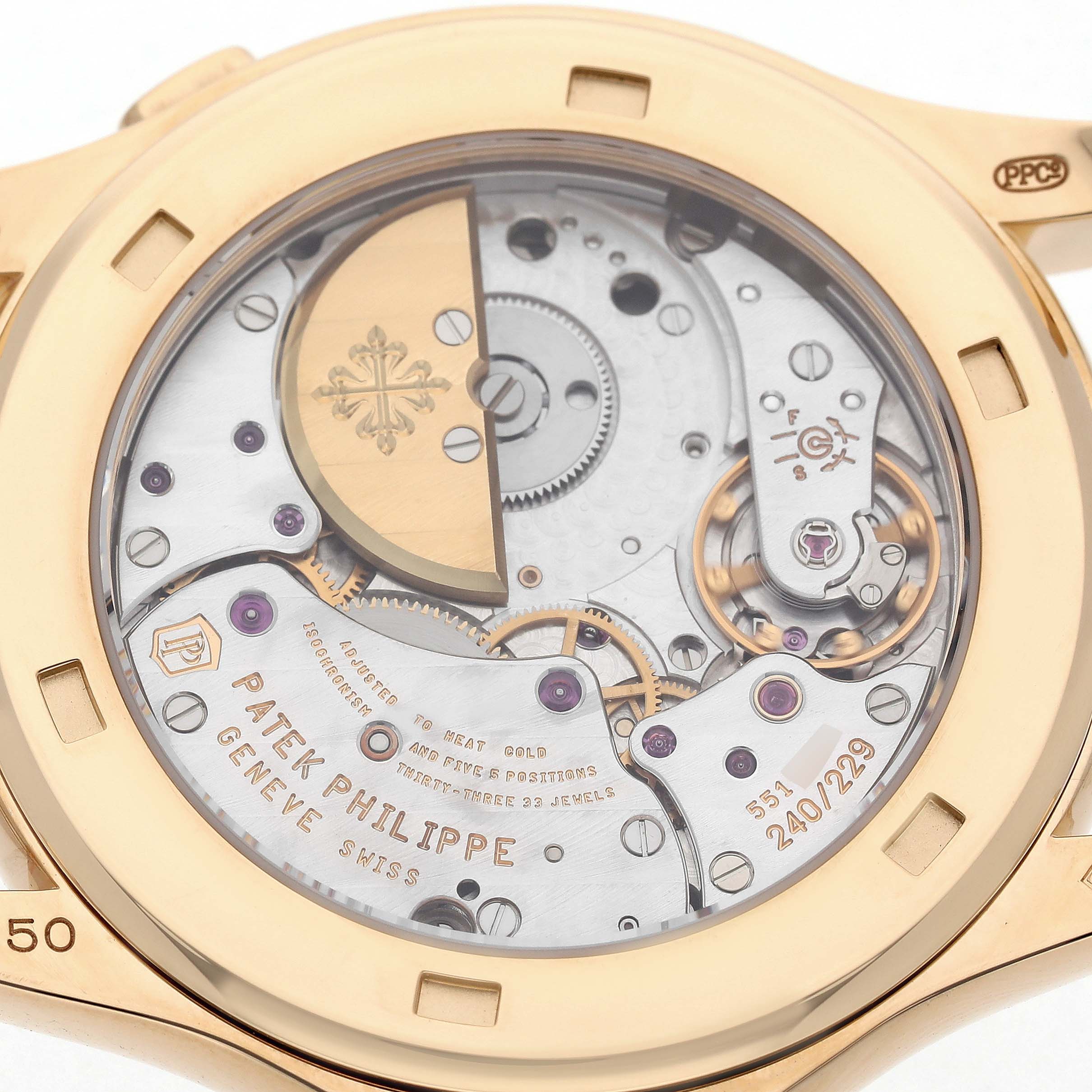 The image shows the back view of a Patek Philippe Complications 5131J-001 Men's Yellow Gold Silver Dial model, highlighting its intricate movement and rotor.