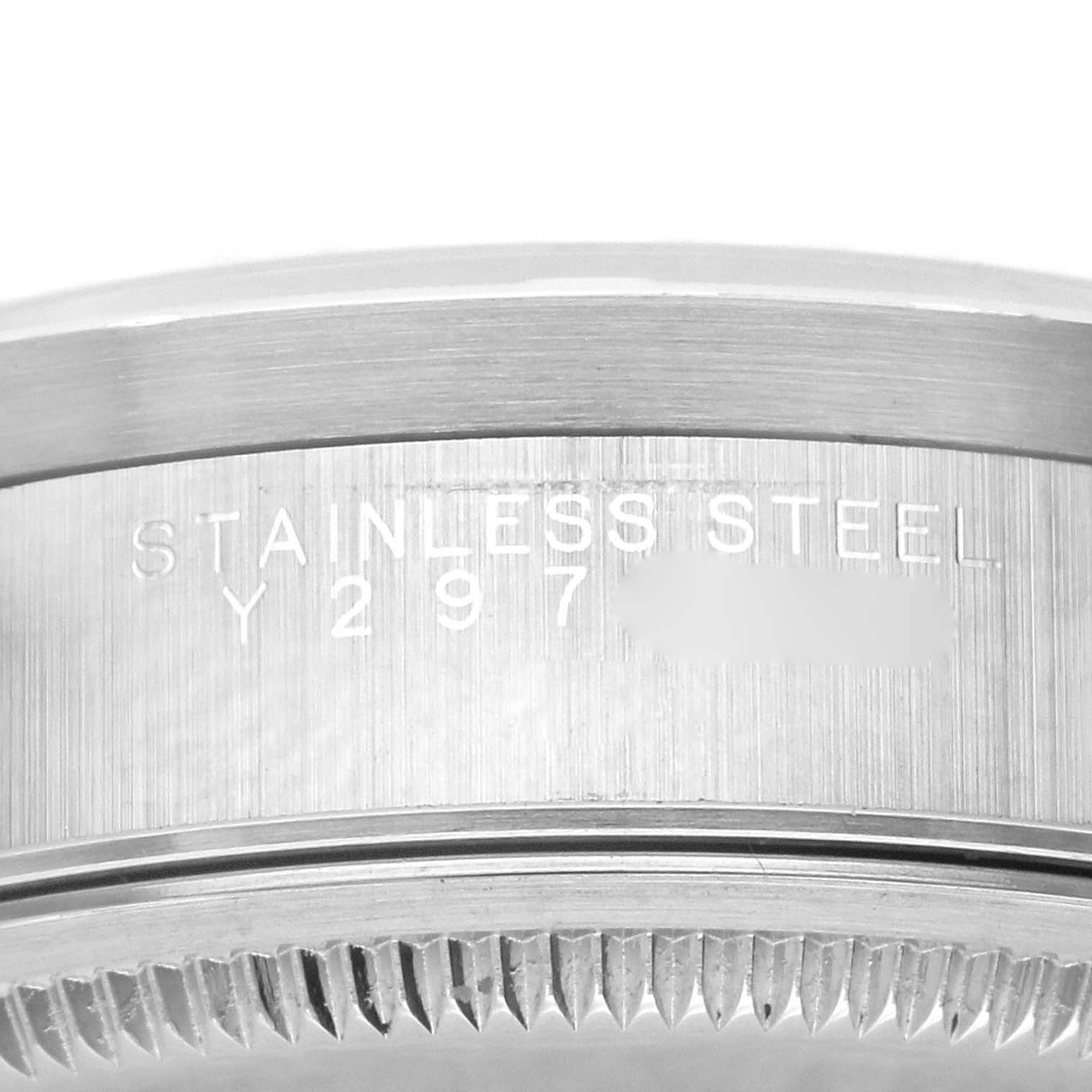 The image shows a close-up of the stainless steel bezel and serial number engraving on a Rolex Air-King 14010 Men's Stainless Steel Blue Dial 14010 Men's Stainless Steel Blue Dial watch.