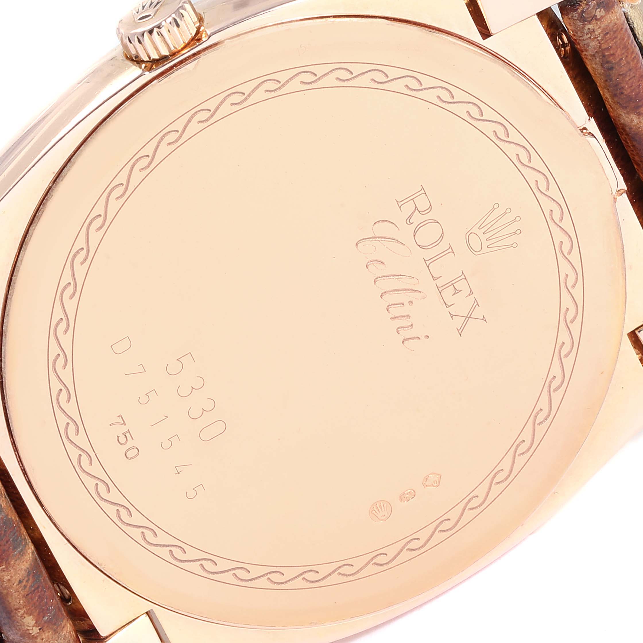 This image shows the back case of a Rolex Cellini 5330 Men's Rose Gold White Dial 5330 Men's Rose Gold White Dial watch, featuring engraved details and part of the crown and strap.