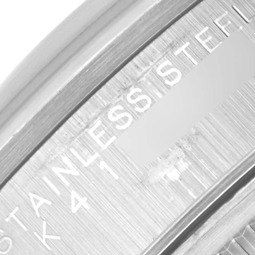 This image shows a close-up angle of the Rolex Date 15200 Men
s Stainless Steel Silver Dial 15200 Men
s Stainless Steel Silver Dial model
s stainless steel bezel with engravings.