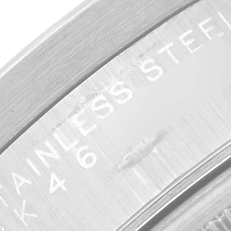 This image shows an extreme close-up of the case back of a Rolex Date 15210 Men's Stainless Steel White Dial 15210 Men's Stainless Steel White Dial model watch, highlighting the "STAINLESS STEEL" engraving.