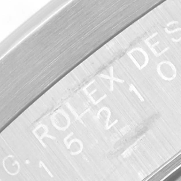 This close-up image shows the serial engraving on the case side of a Rolex Date 15210 Men's Stainless Steel White Dial 15210 Men's Stainless Steel White Dial model watch.