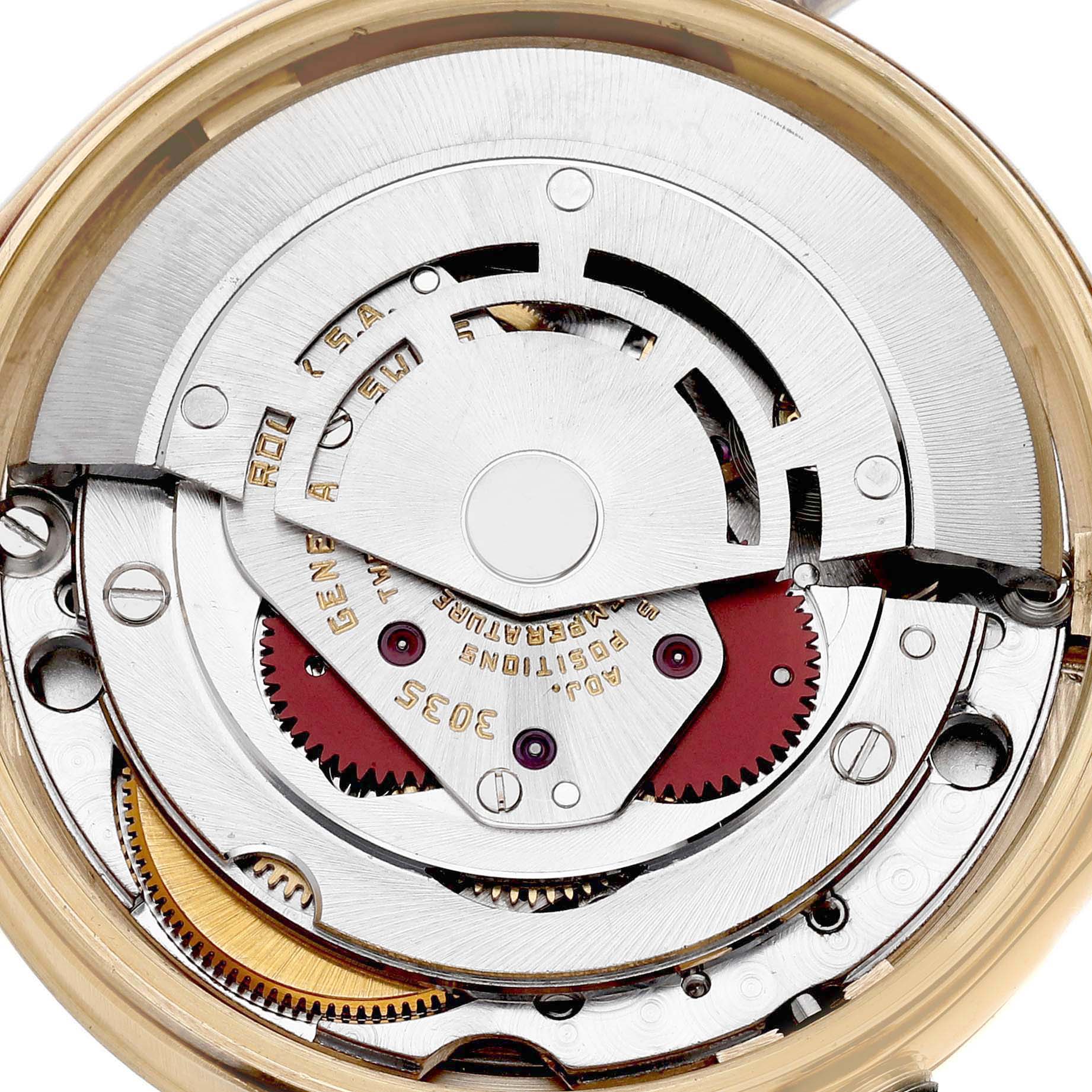 The image shows the intricate movement of a Rolex Date 15037 Men's Yellow Gold Champagne Dial model watch from a top-down angle, highlighting gears and components.