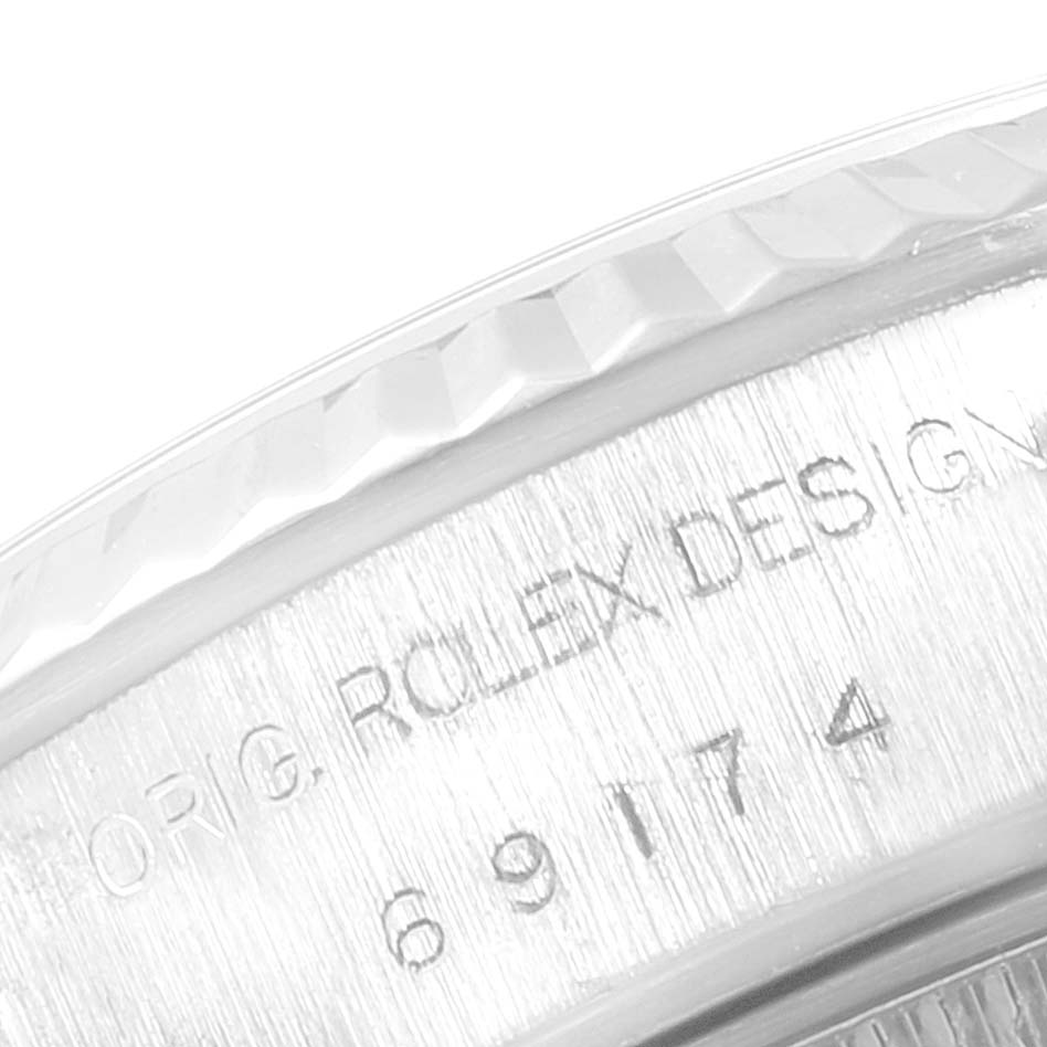 This image shows a close-up of the case side, bezel, and engraving of a Rolex Datejust 69174 Women's Stainless Steel Pink Dial 69174 Women's Stainless Steel Pink Dial model watch.