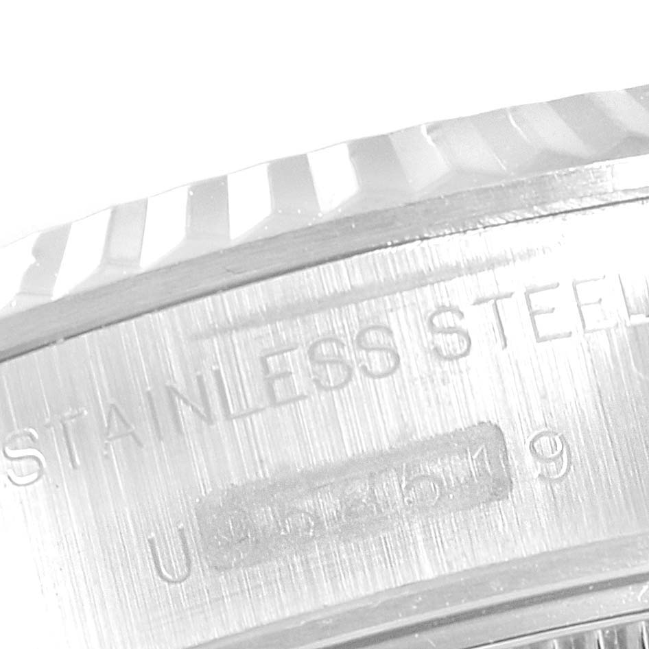 This close-up image shows part of the stainless steel casing and serial number of a Rolex Datejust 69174 Women's Stainless Steel Pink Dial 69174 Women's Stainless Steel Pink Dial watch.