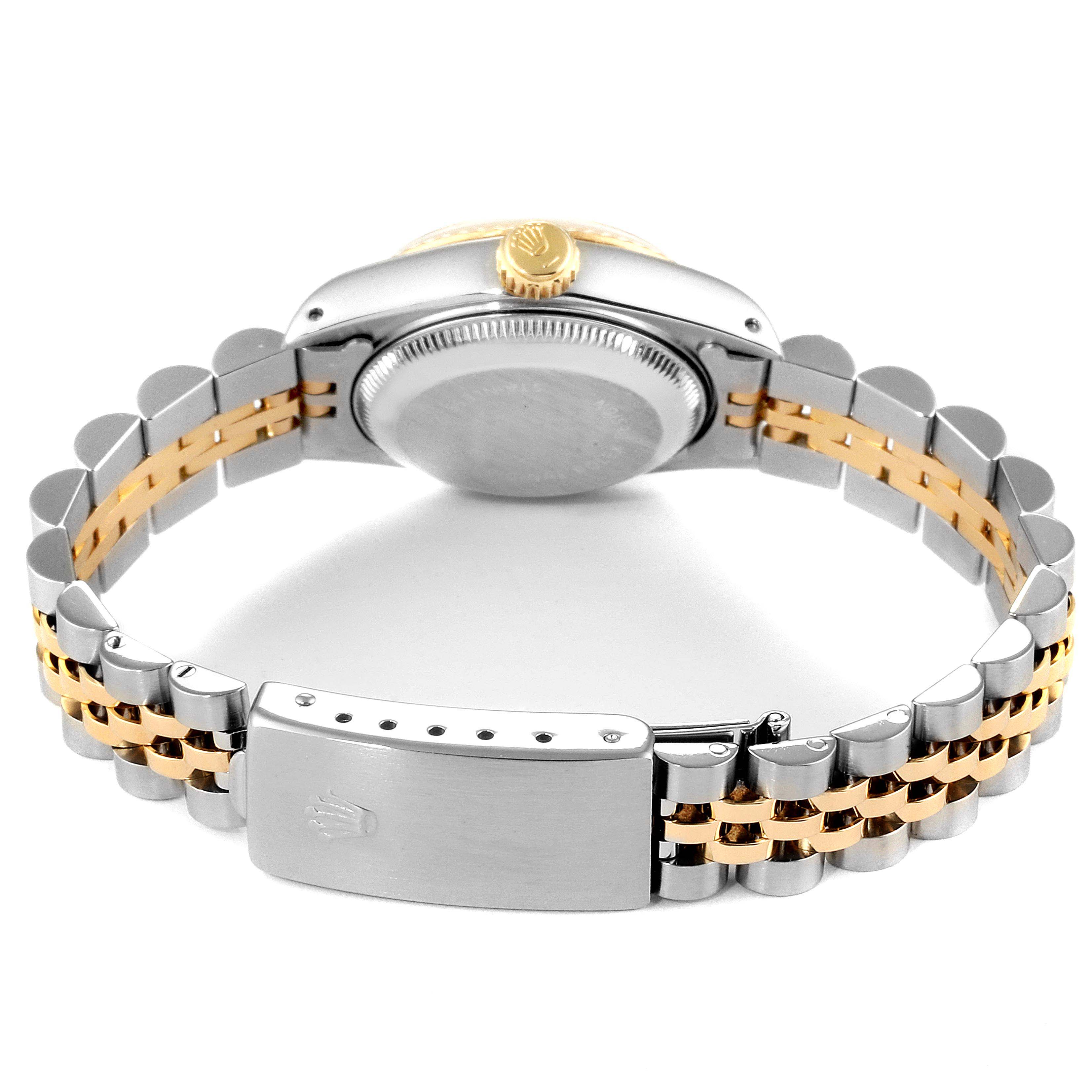 The image shows the back view of the Rolex Datejust 69173 Women
s Steel and Gold (two tone) Champagne Dial 69173 Women
s Steel and Gold (two tone) Champagne Dial watch, highlighting the caseback, crown, and bracelet clasp.