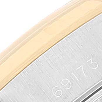 This image shows a close-up of the Rolex Datejust 69173 Women
s Steel and Gold (two tone) Champagne Dial 69173 Women
s Steel and Gold (two tone) Champagne Dial model
s serial number engraving on the watch case. 