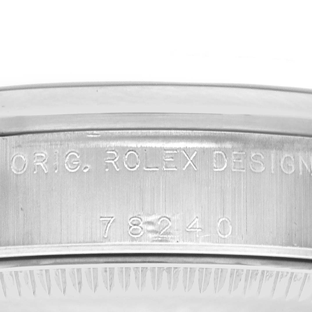 The image shows the side profile of a Rolex Mid-Size 78240 Women
s Stainless Steel Black Dial 78240 Women
s Stainless Steel Black Dial watch bezel, featuring the "ORIG. ROLEX DESIGN" engraving.
