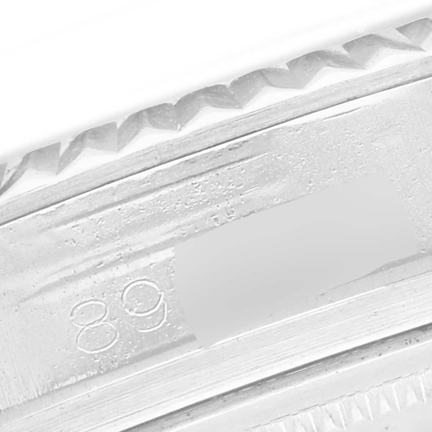 The image shows a close-up of the Rolex Datejust 1601 Men
s Stainless Steel Silver Dial 1601 Men
s Stainless Steel Silver Dial
s fluted bezel and engraved serial number on the side.